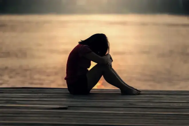 feel empty even when everything seems fine person sitting alone looking calm but emotionally disconnected