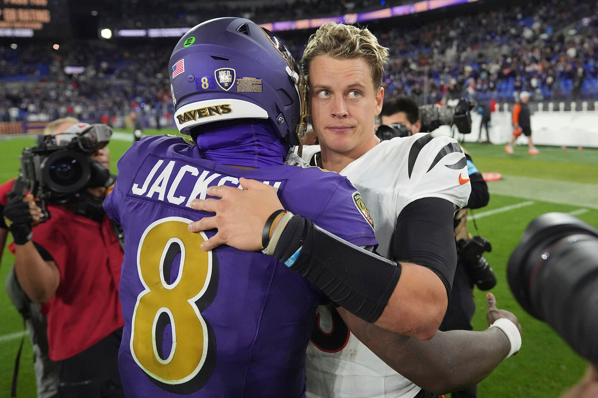 Cincinnati Bengals quarterback Joe Burrow, right, and Baltimore Ravens quarterback Lamar Jackson, left, embrace after an NFL football game