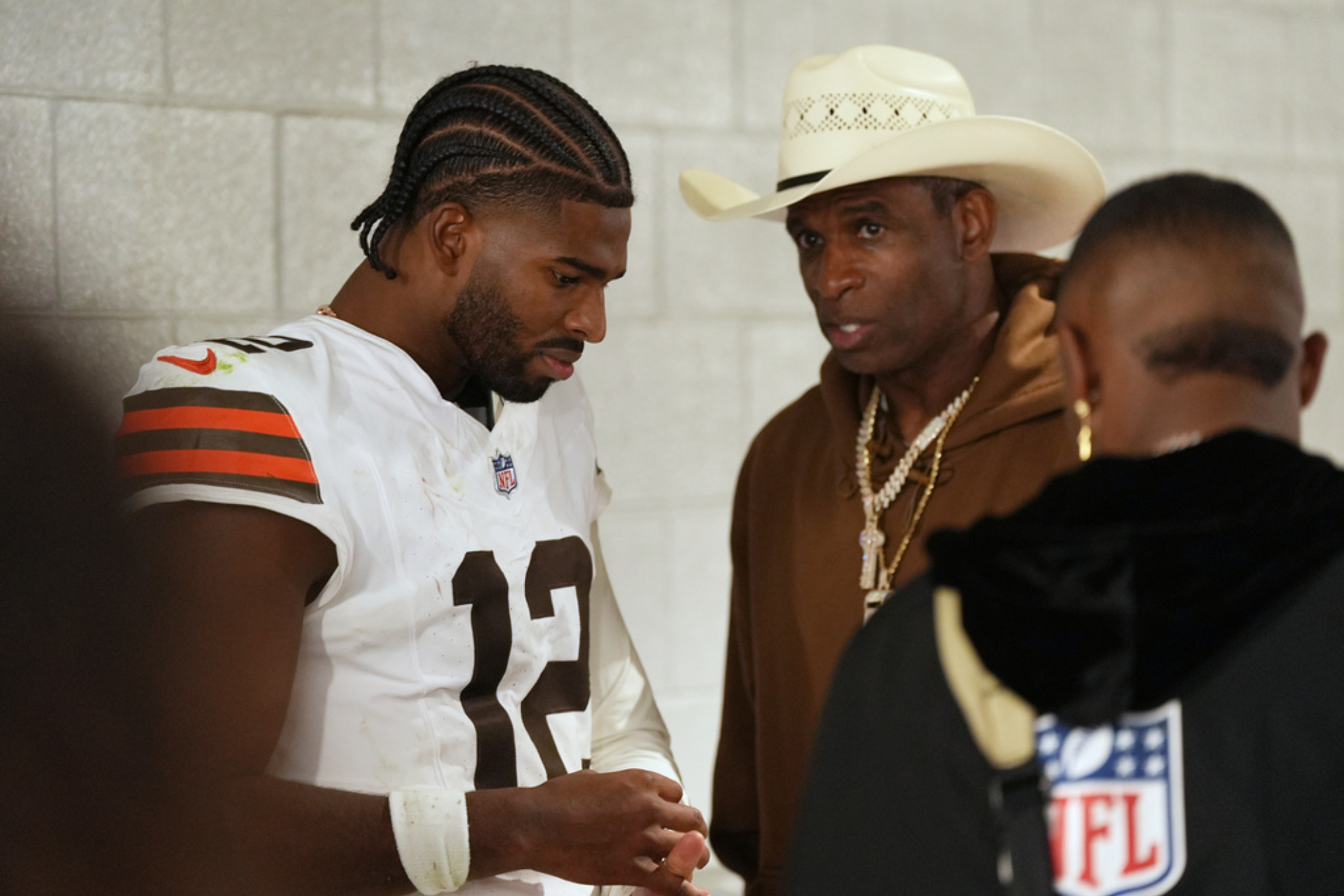 Cleveland Browns quarterback Shedeur Sanders (12) speaks with his father Deion Sanders