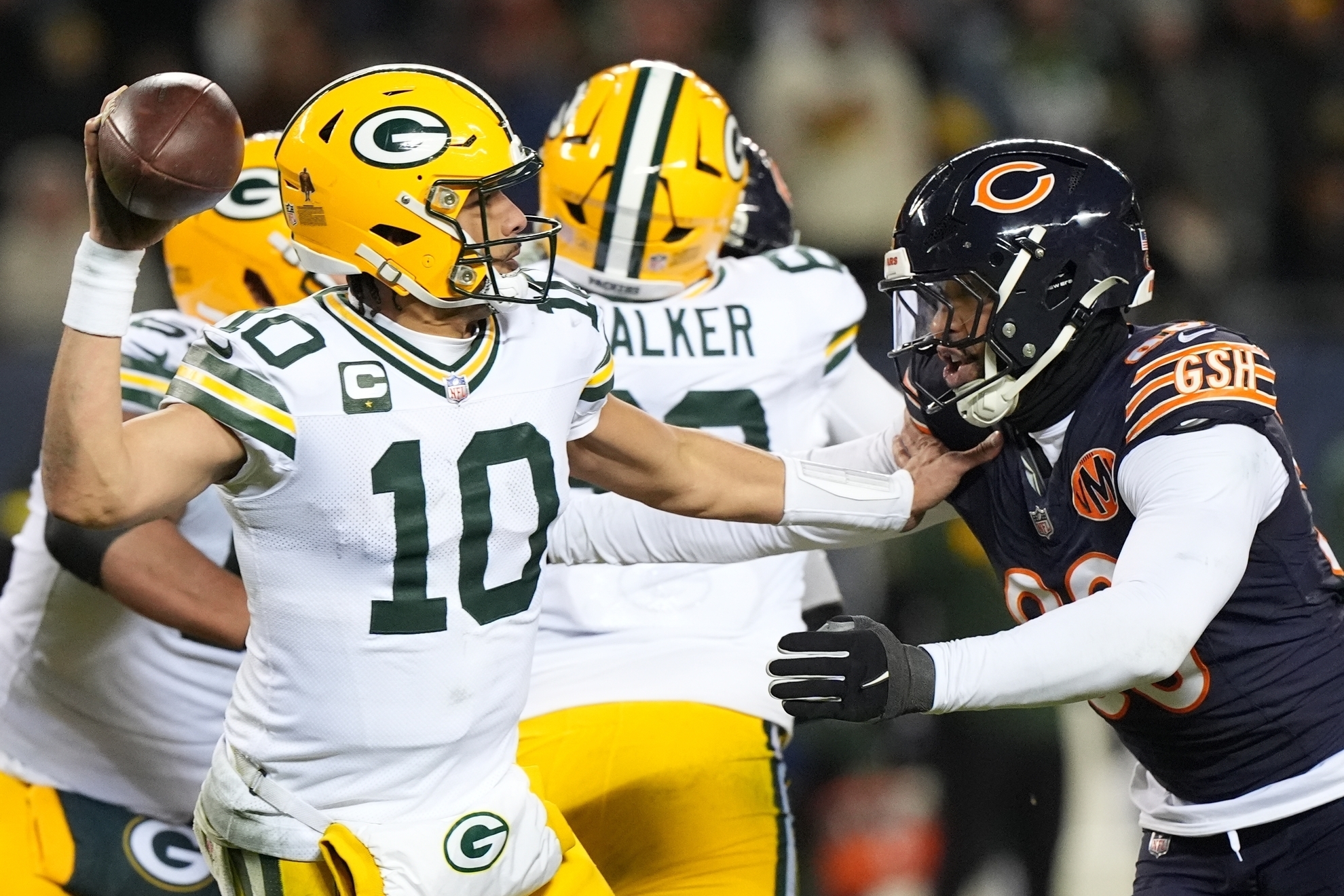 Green Bay Packers' Jordan Love throws as he is hit by Chicago Bears' Montez Sweat