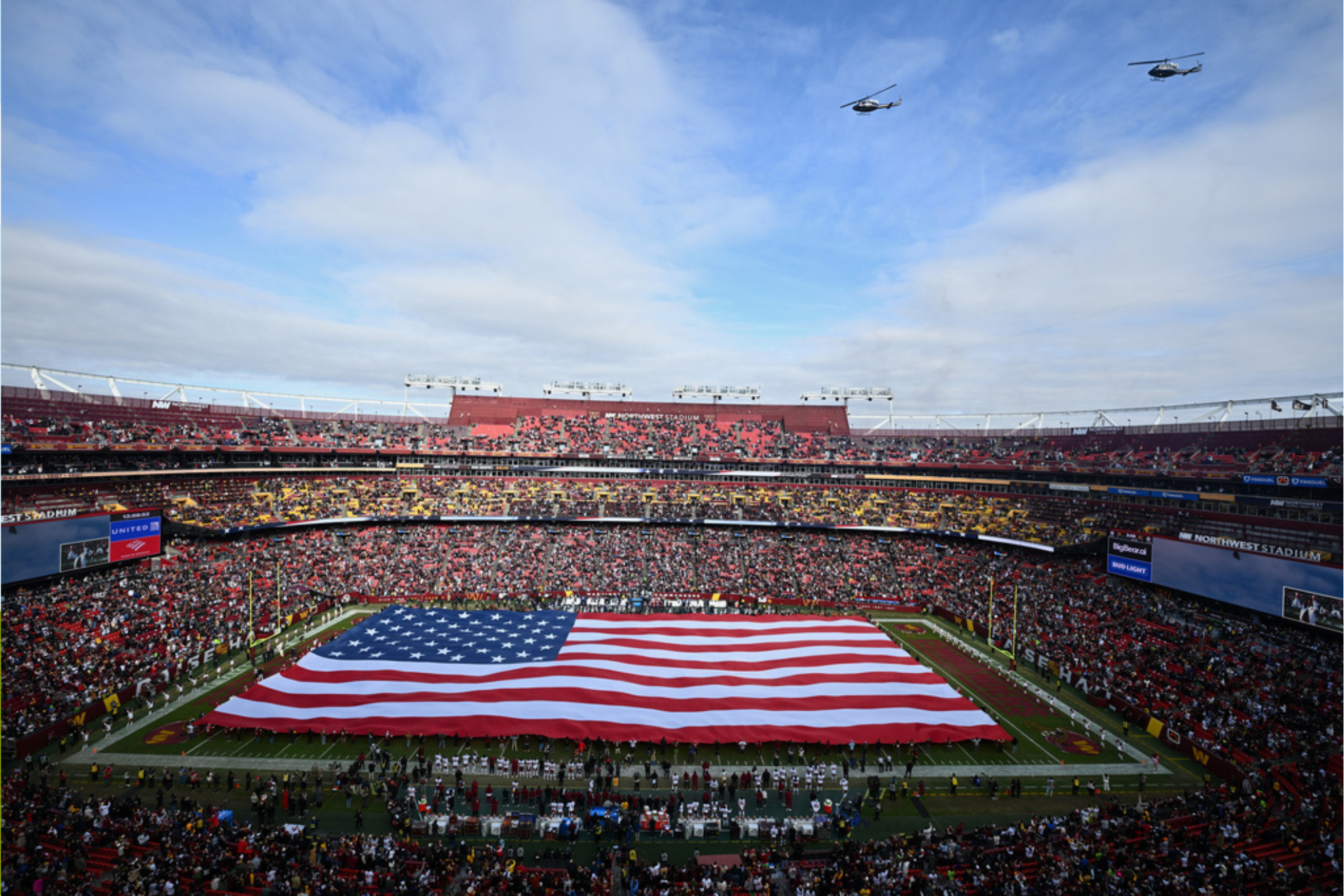 A United States flag is unfurled on the field in this general view of Northwest Stadium before an NFL football game