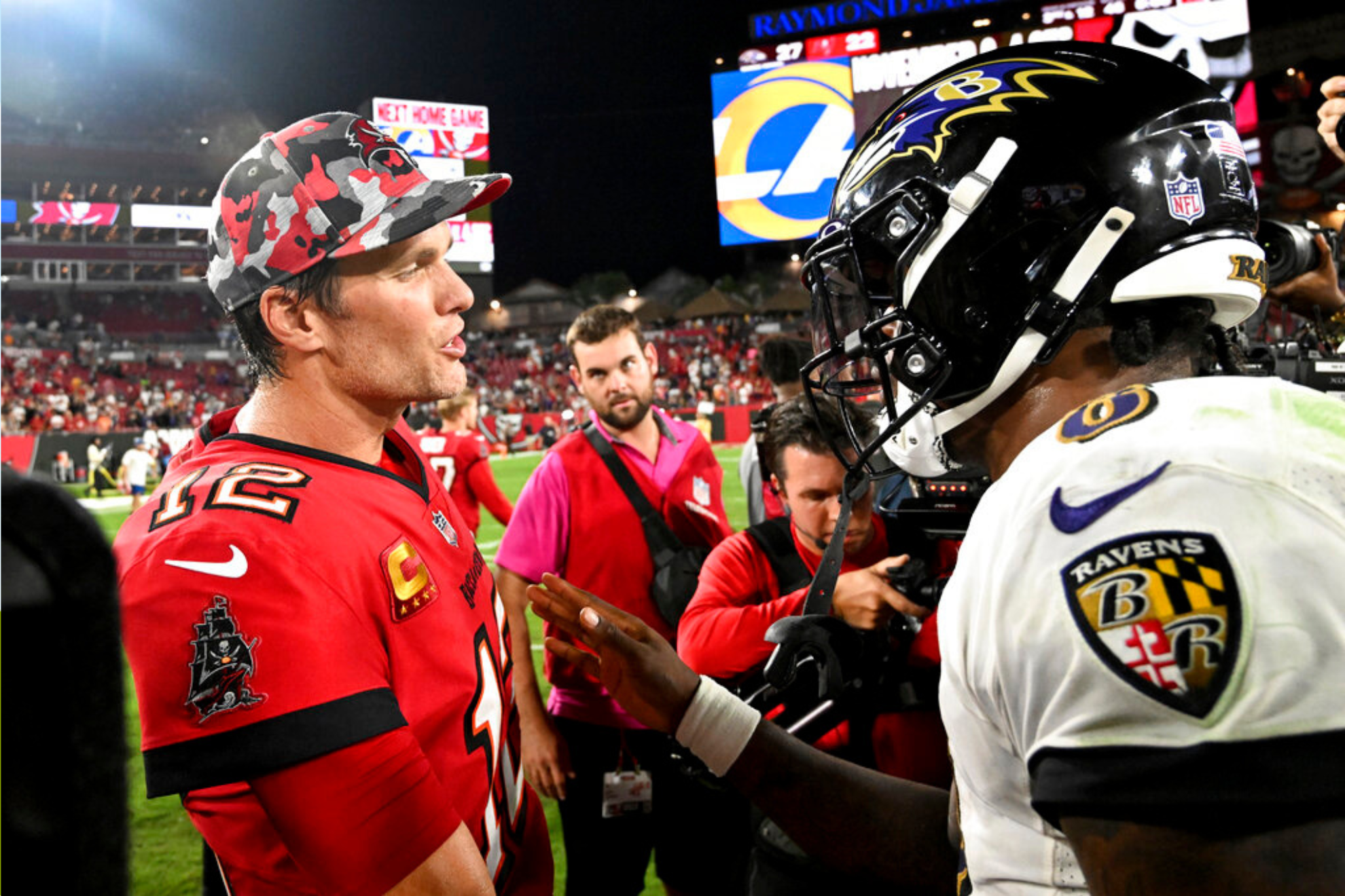 Tampa Bay Buccaneers quarterback Tom Brady, left, and Baltimore Ravens quarterback Lamar Jackson shake hands following an NFL football game