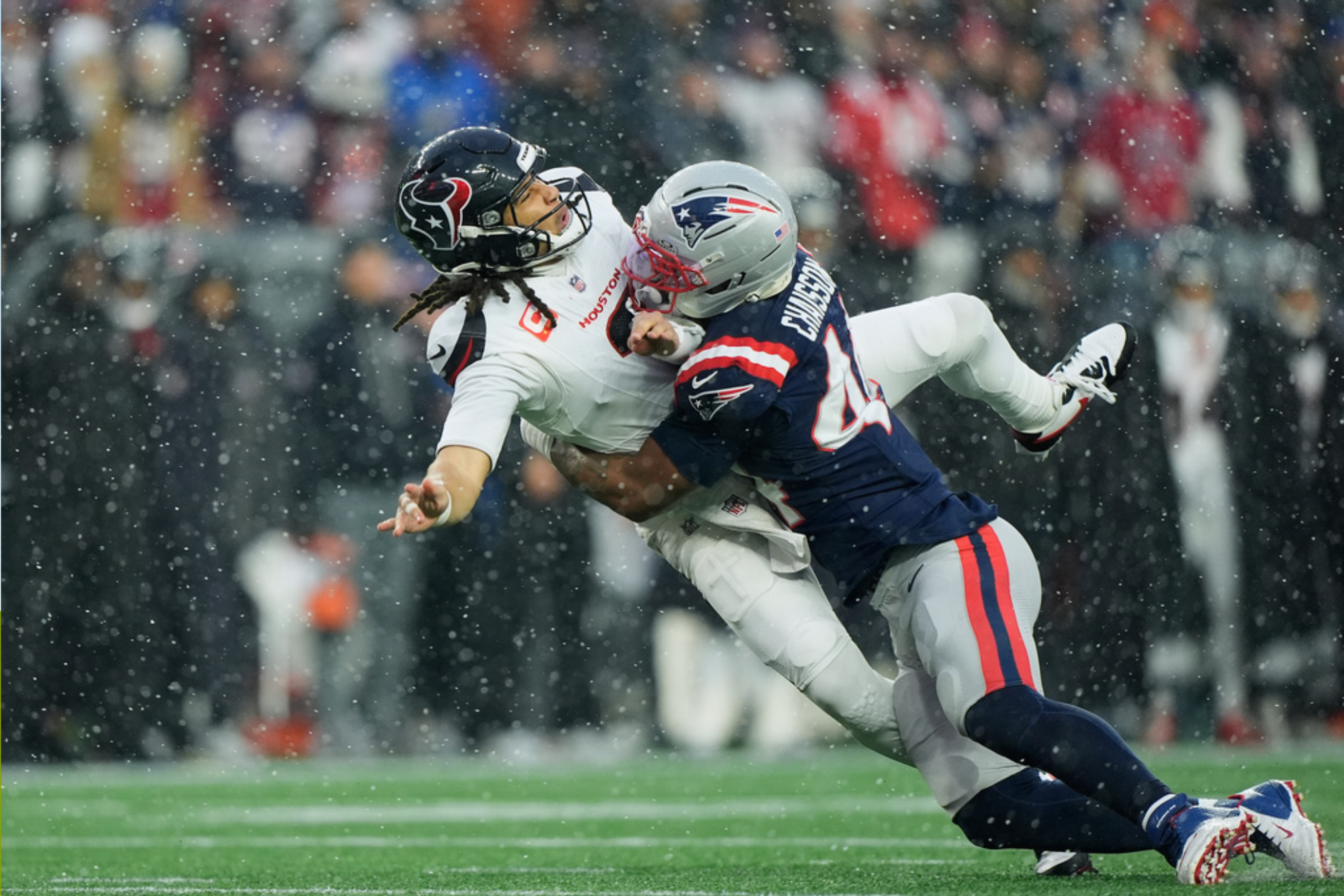 New England Patriots linebacker K'lavon Chaisson, right, hits Houston Texans quarterback C.J. Stroud during the first half of an NFL divisional playoff football game