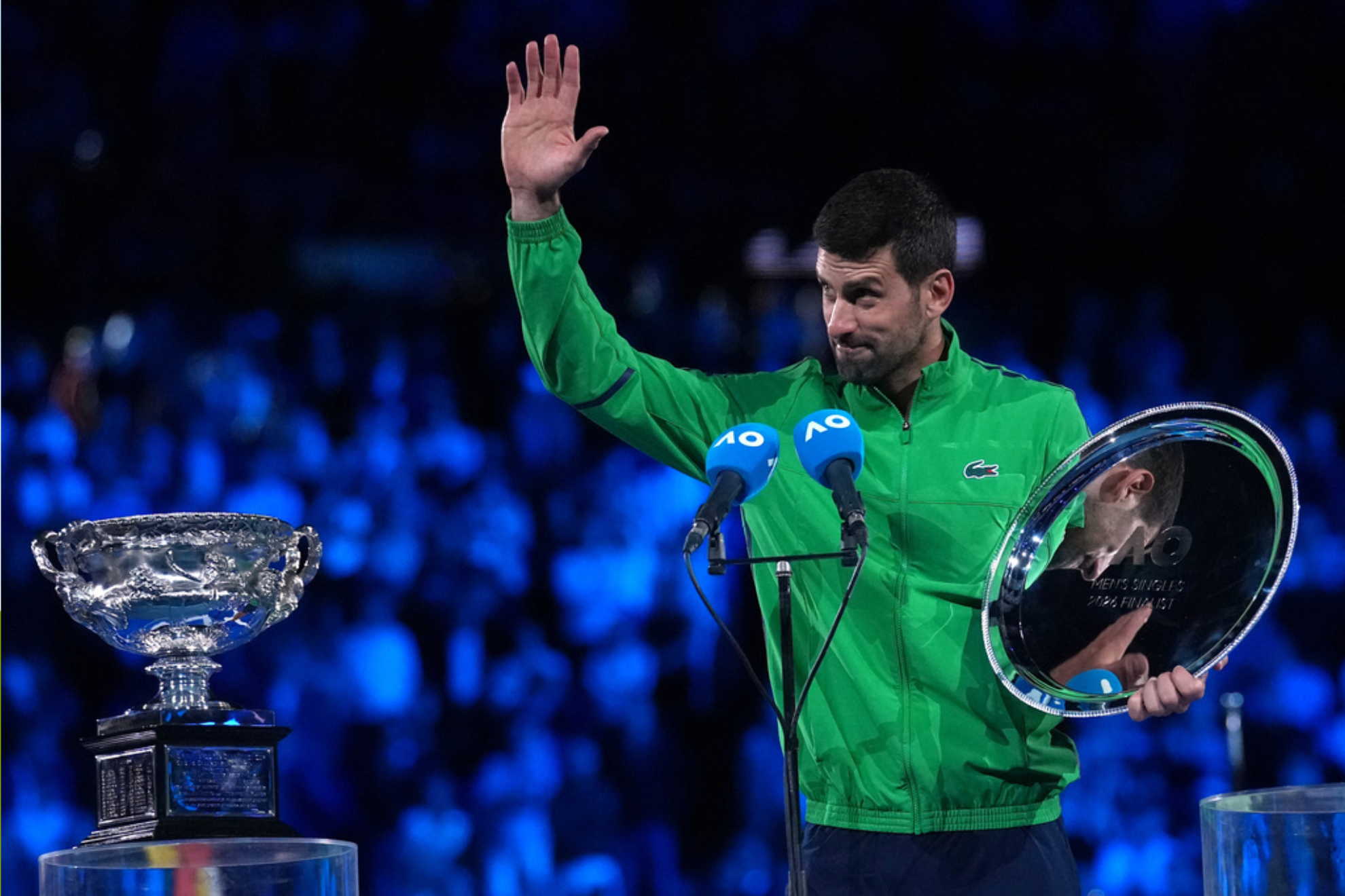 Novak Djokovic of Serbia waves during his speech following his loss to Carlos Alcaraz at the Australian Open 2026