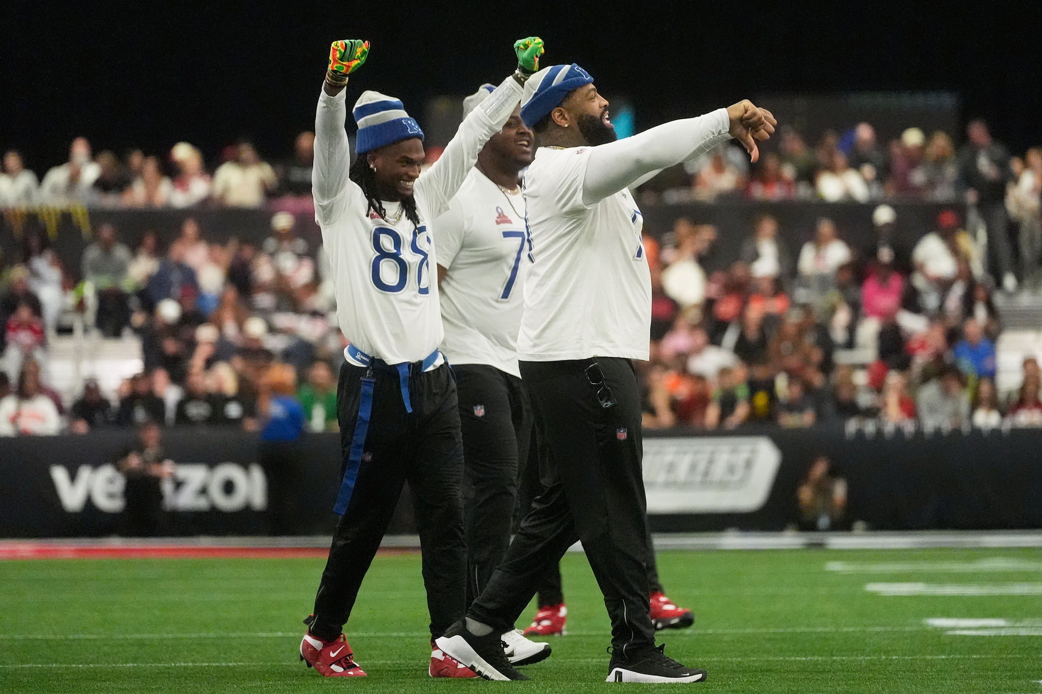 NFC wide receiver CeeDee Lamb of the Dallas Cowboys, from left, offensive guard Tyler Smith, of the Dallas Cowboys and offensive tackle Trent Williams, of the San Francisco 49ers, react toward the AFC sideline during the second half of NFL Pro Bowl football game in San Francisco, Tuesday, Feb. 3, 2026. (AP Photo/Jeff Chiu)