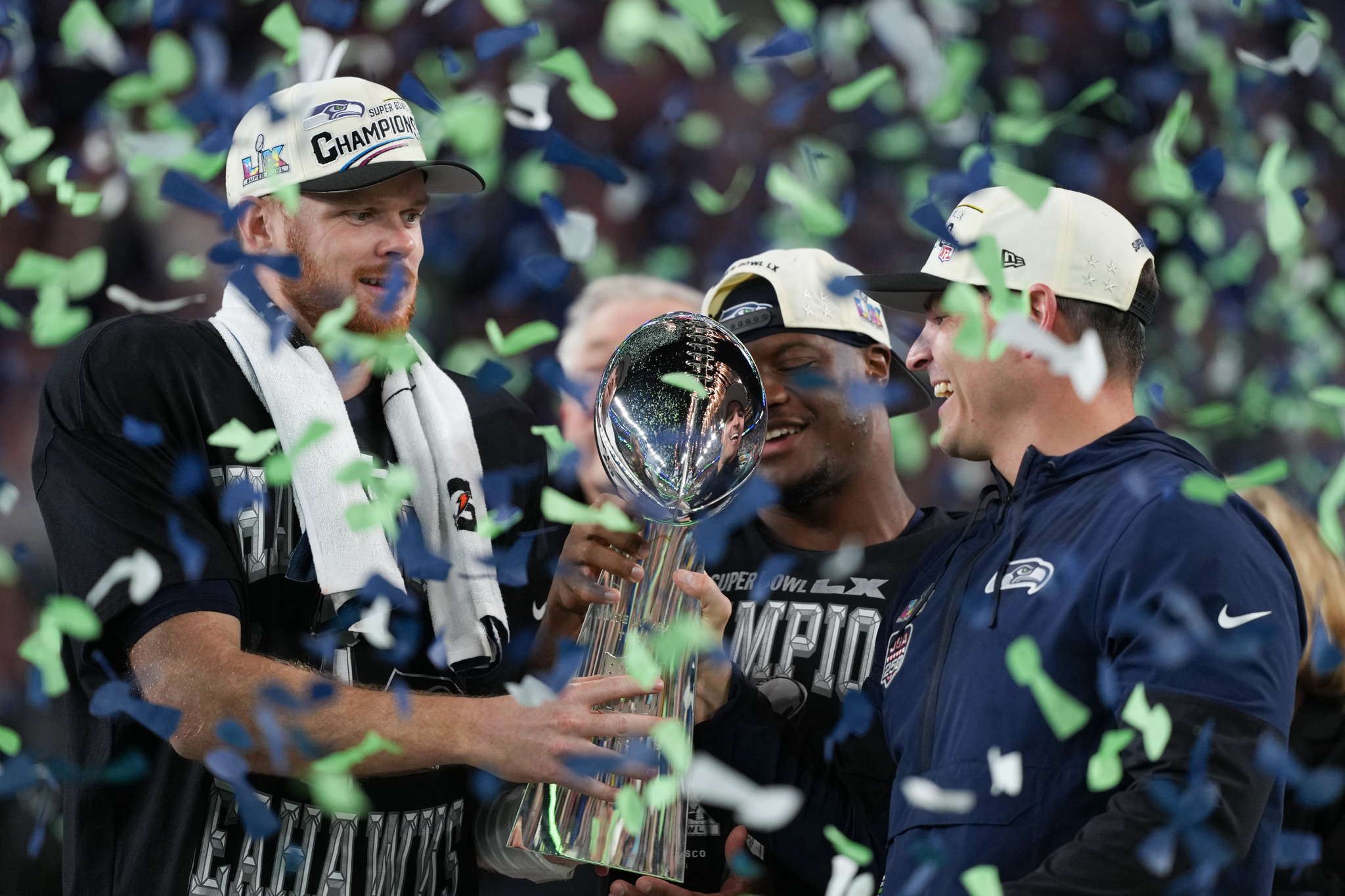 Seattle Seahawks head coach Mike Macdonald and quarterback Sam Darnold, left, hold the Lombardi Trophy
