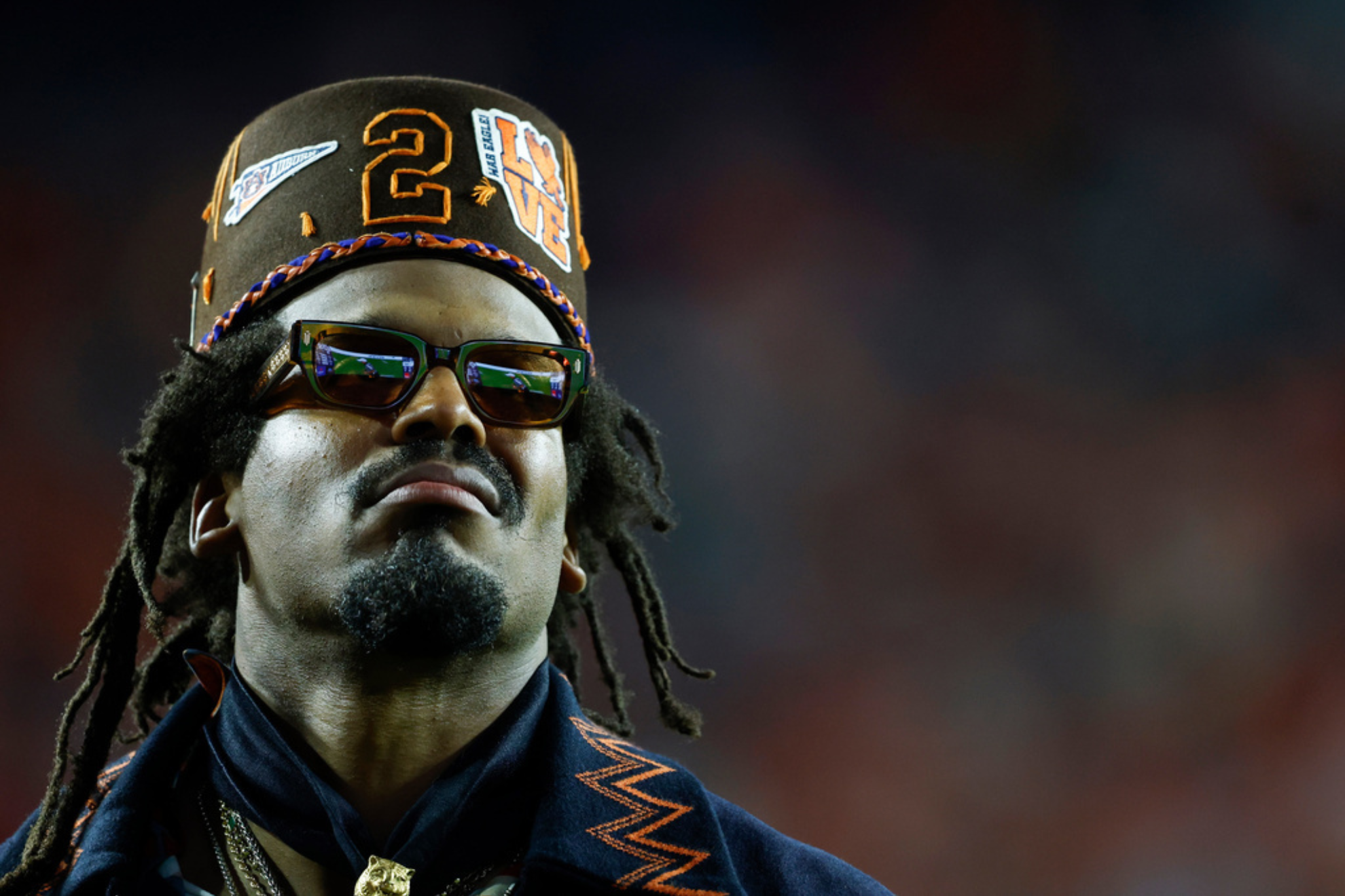 Former Auburn quarterback and NFL player Cam Newton watches a play during the first half of an NCAA college football game