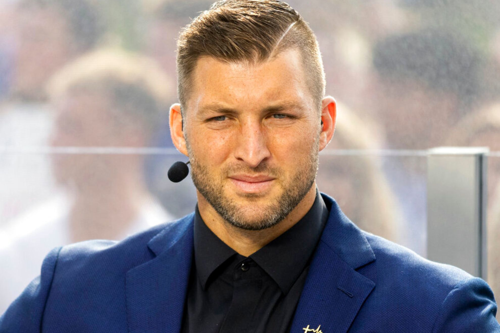 SEC Nation host Tim Tebow listens to his co-hosts during the SEC Nation broadcast.