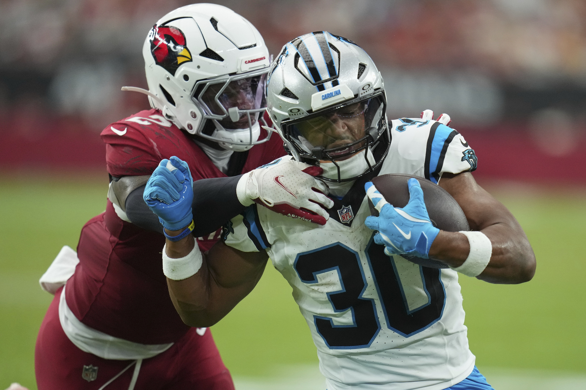Carolina Panthers running back Chuba Hubbard is tackled by Arizona Cardinals linebacker Mack Wilson Sr.