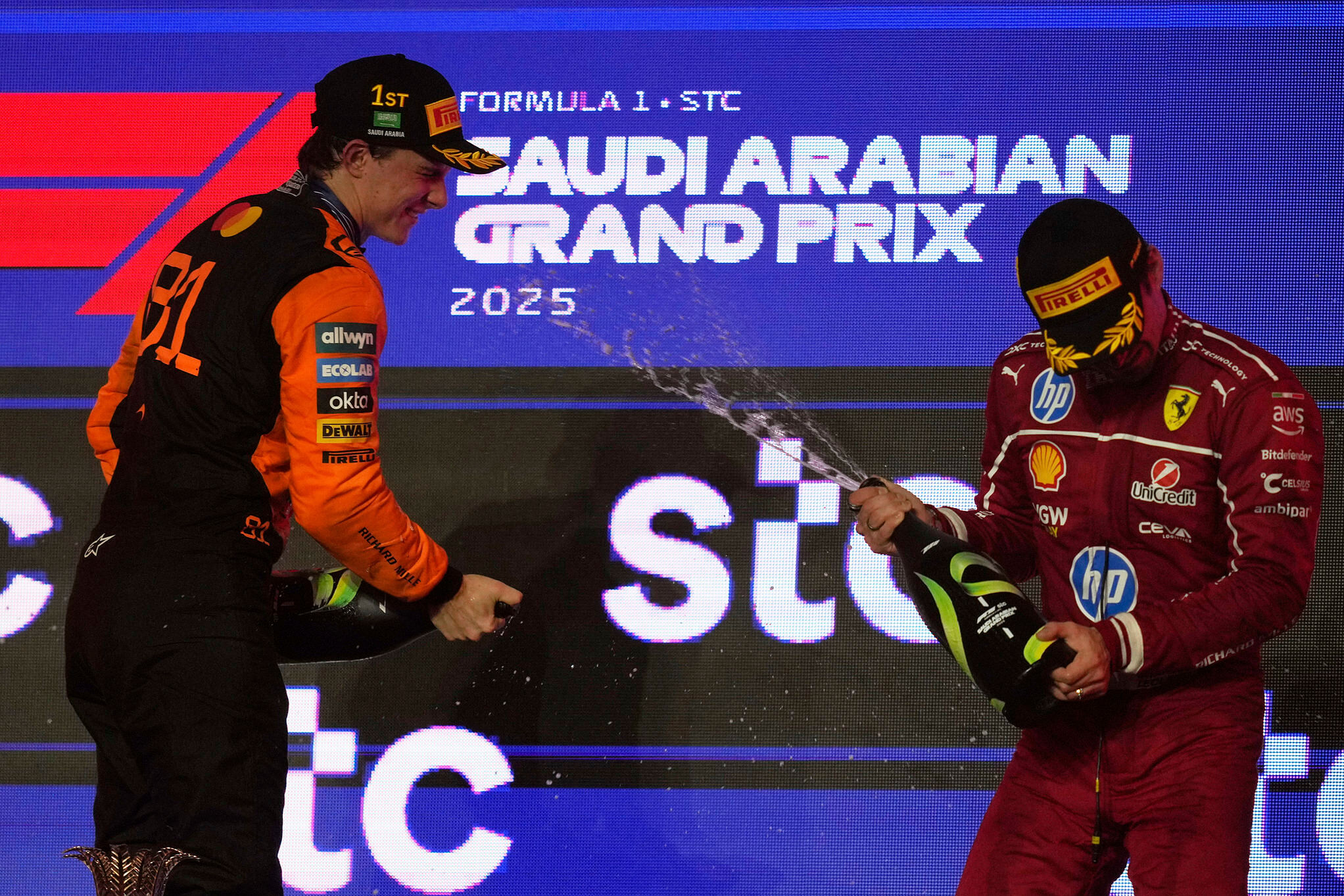 Race winner McLaren driver Oscar Piastri of Australia, left, sprays champagne with third placed Ferrari driver Charles Leclerc of Monaco after the Formula One Saudi Arabian Grand Prix
