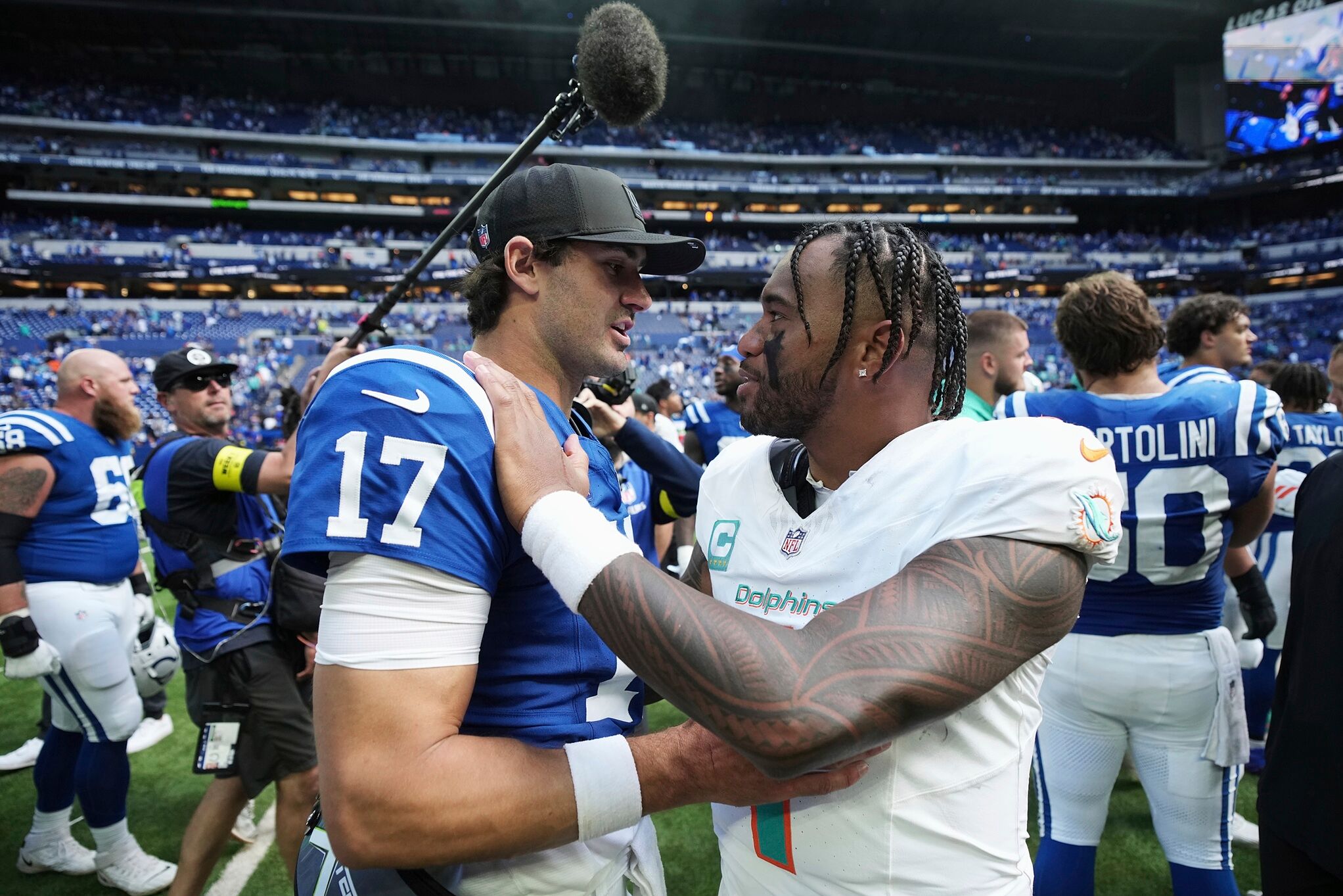 Miami Dolphins quarterback Tua Tagovailoa (1) and Indianapolis Colts quarterback Daniel Jones (17) meet after an NFL football game