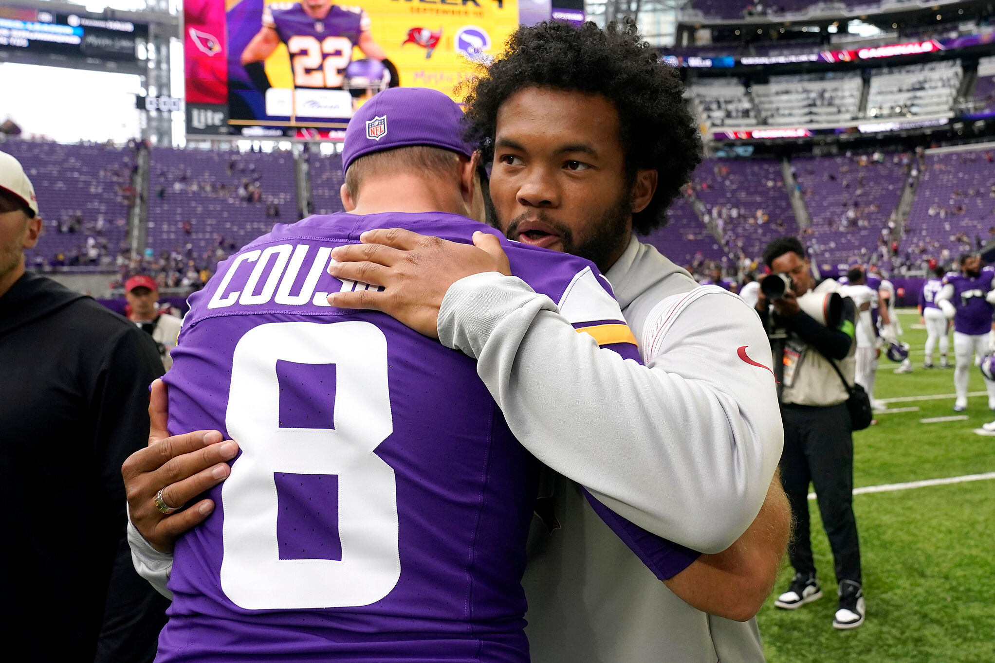 Arizona Cardinals quarterback Kyler Murray is embraced by Minnesota Vikings quarterback Kirk Cousins (8) after an NFL preseason football game