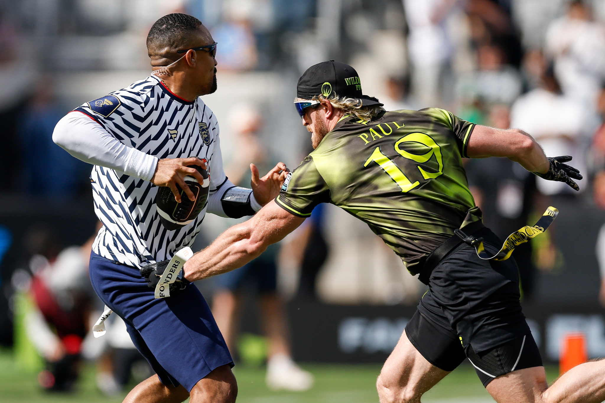 Jalen Hurts has his flag pulled by Logan Paul during the Fanatics Flag Football Classic