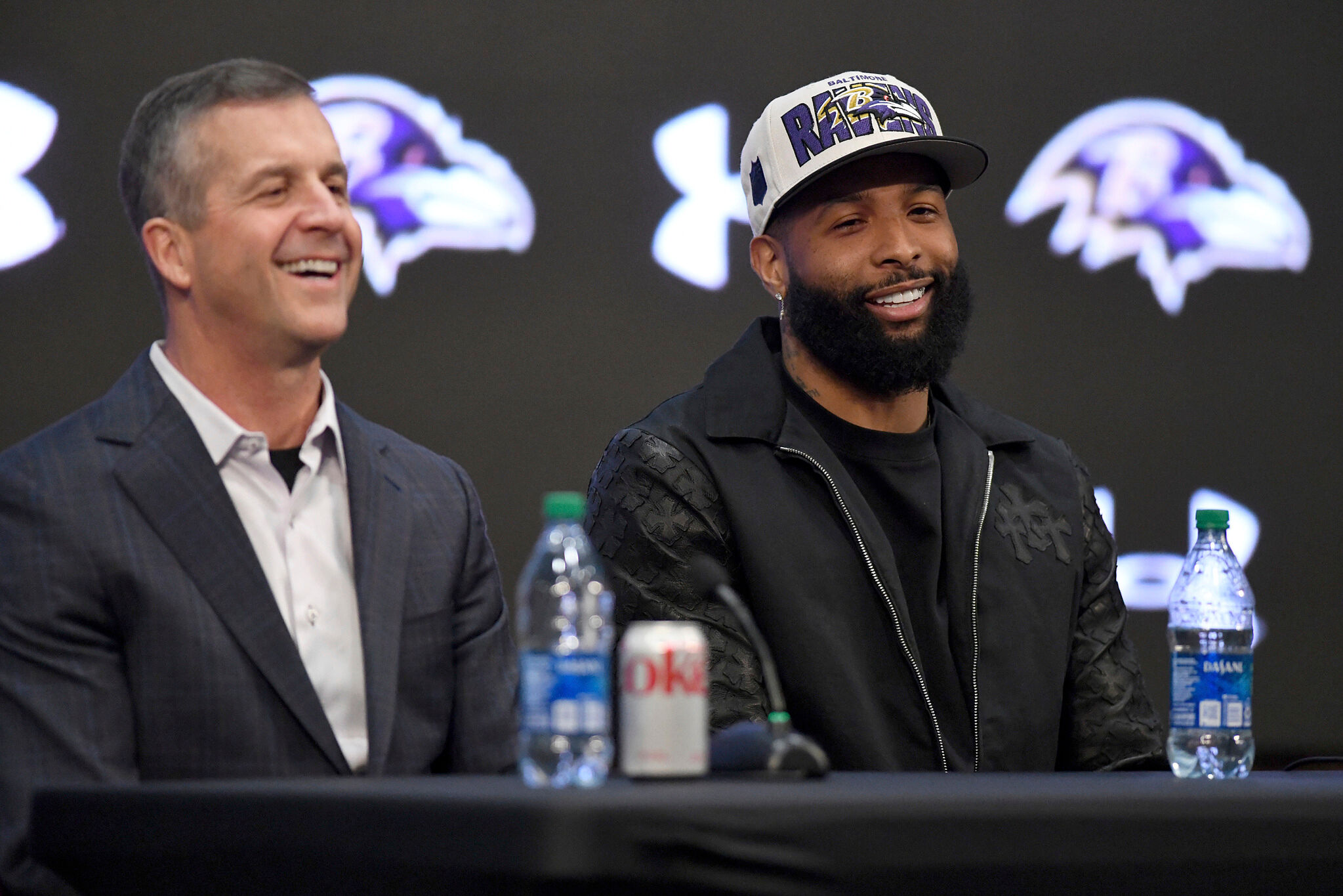 Recently signed Baltimore Ravens NFL football wide receiver Odell Beckham Jr., right, sits with head coach John Harbaugh