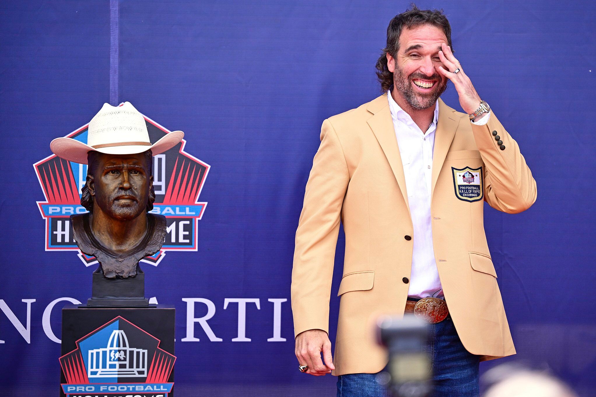 Former NFL player Jared Allen poses with his bust during an induction ceremony at the Pro Football Hall of Fame in Canton, Ohio