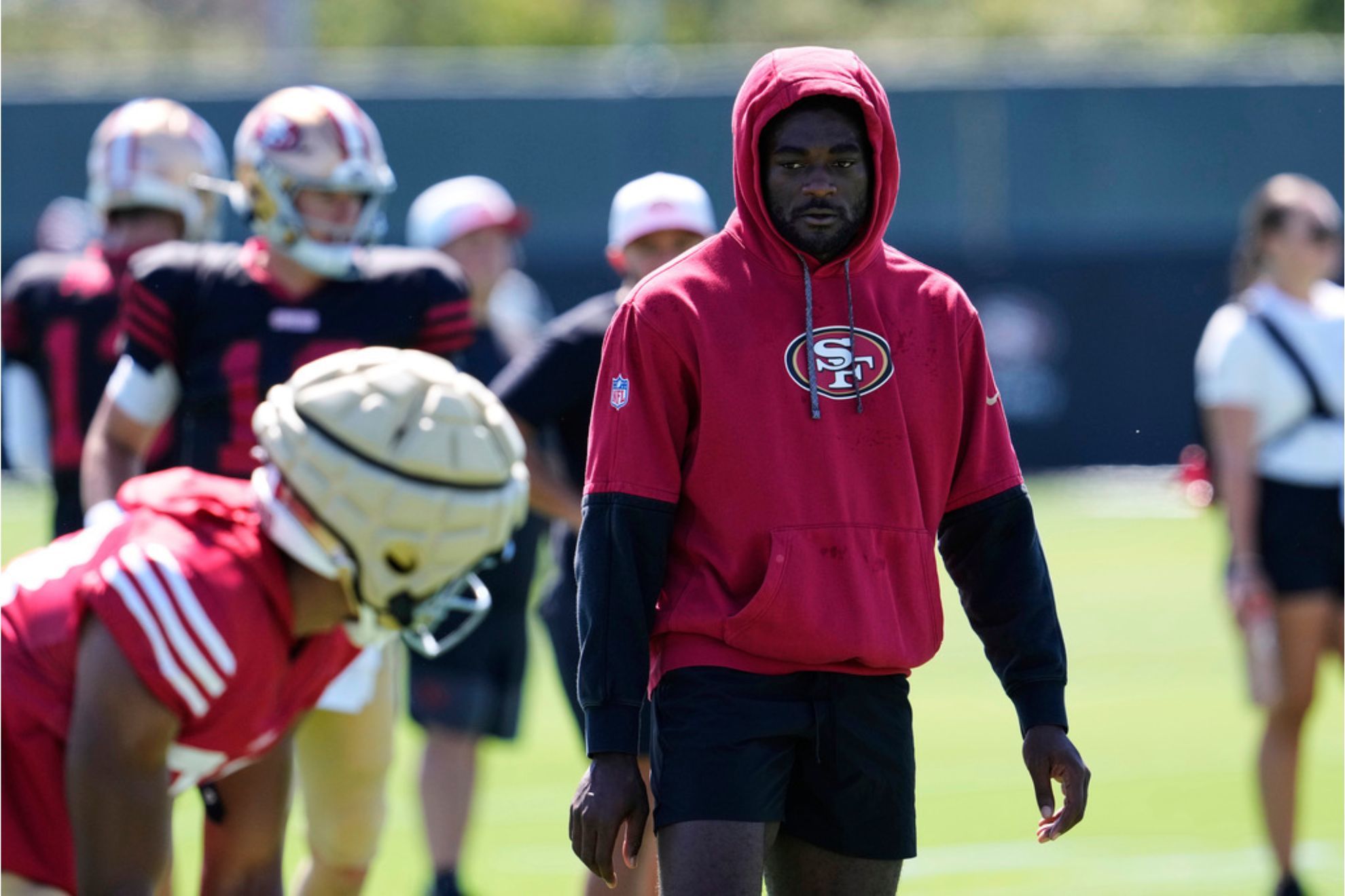San Francisco 49ers' Brandon Aiyuk watches fellow wide receivers run a drill during practice at the team's NFL football training camp