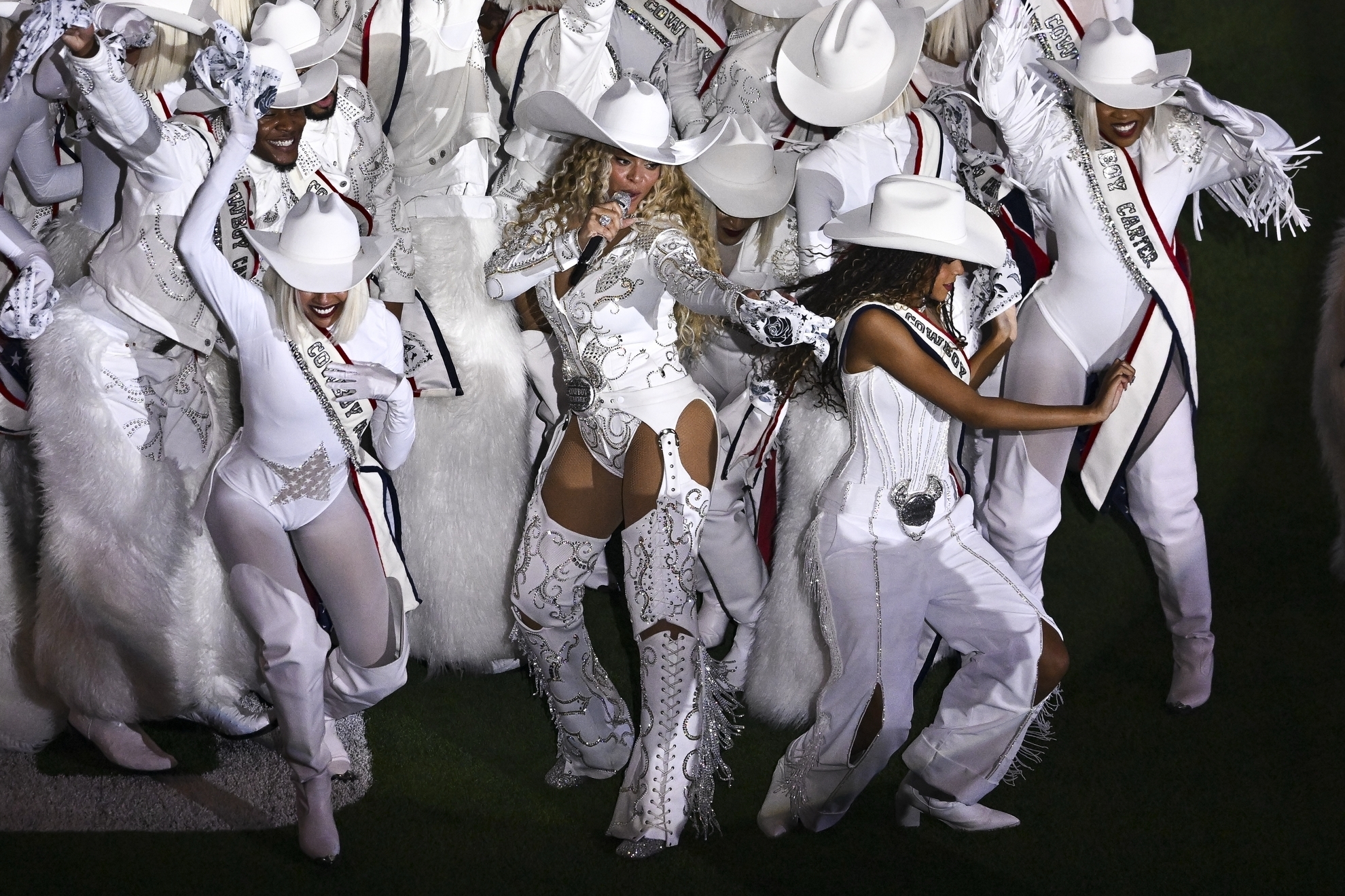 Beyoncé, center, is joined by her daughter Blue Ivy, right, during a halftime performance in an NFL football game