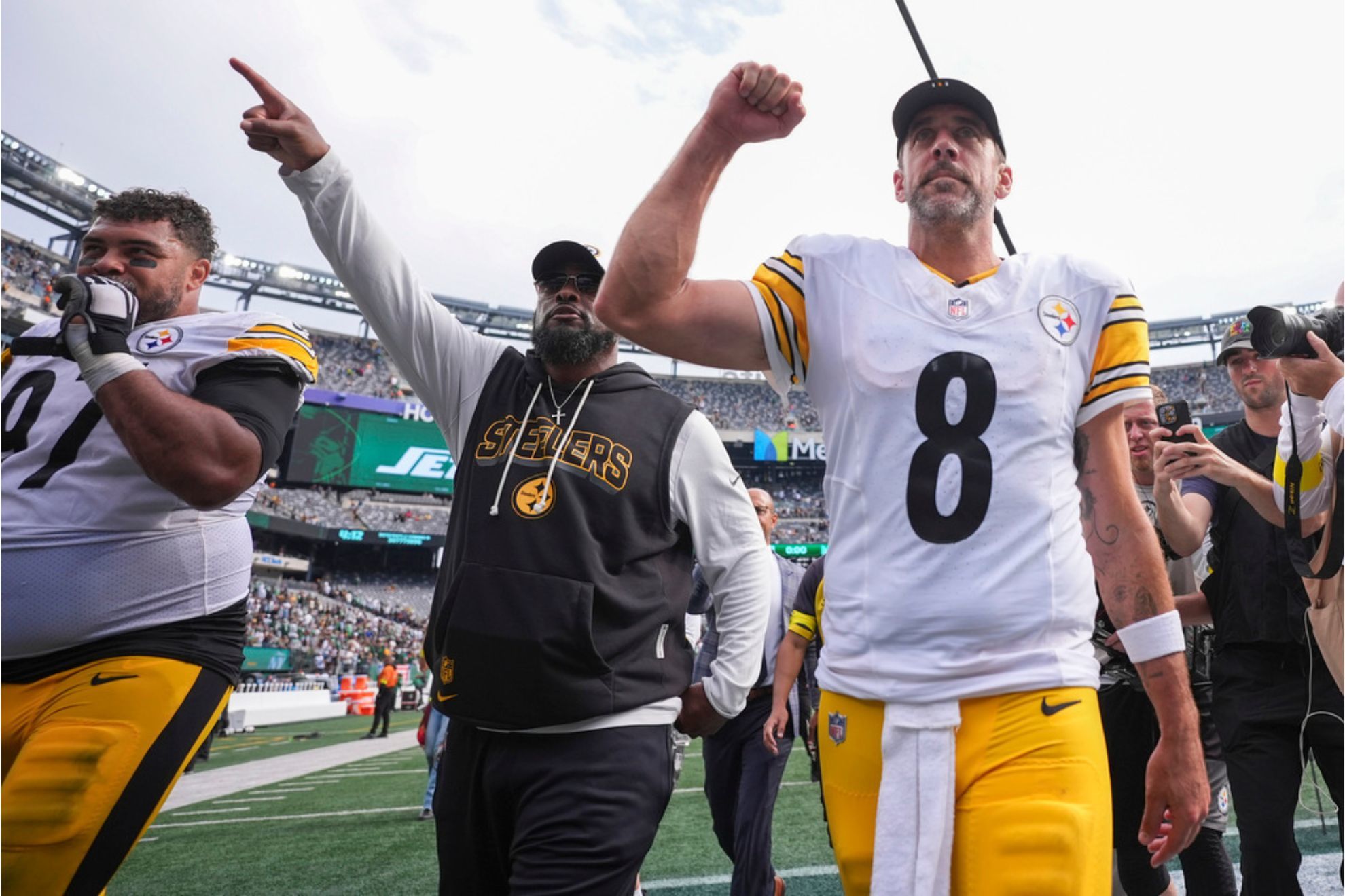 Pittsburgh Steelers defensive tackle Cam Heyward, head coach Mike Tomlin, and quarterback Aaron Rodgers leave the field following a game against the New York Jets