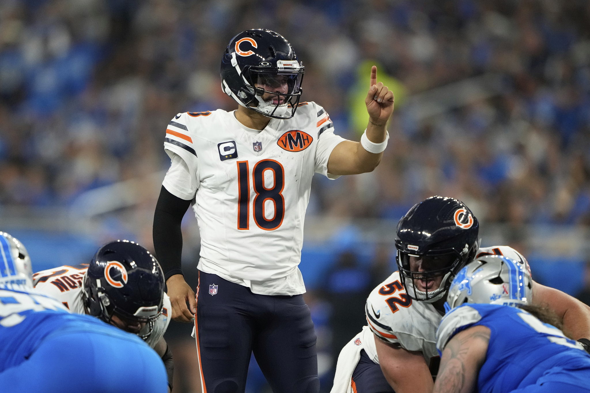 Chicago Bears quarterback Caleb Williams (18) signals.