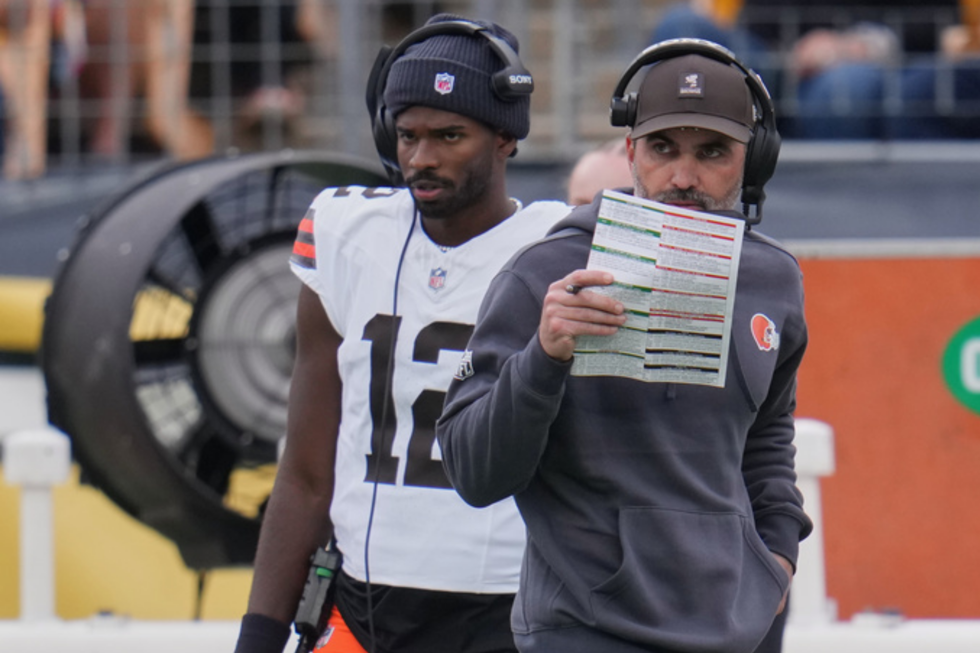 Cleveland Browns head coach Kevin Stefanski, right, walks on the sidelines past quarterback Shedeur Sanders