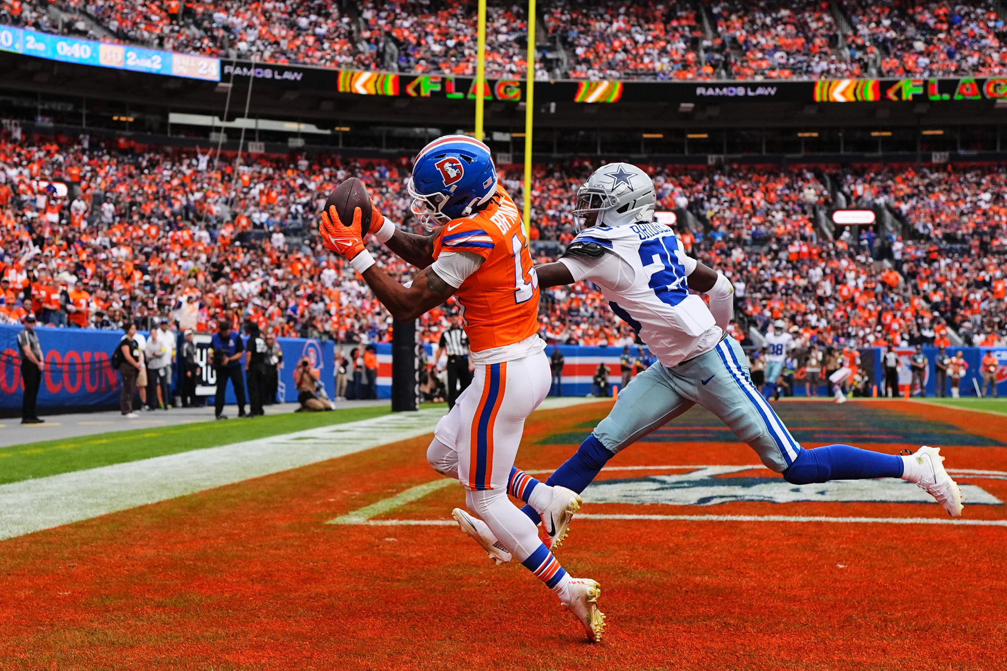 Denver Broncos wide receiver Pat Bryant catches a touchdown as Dallas Cowboys cornerback Trikweze Bridges defends