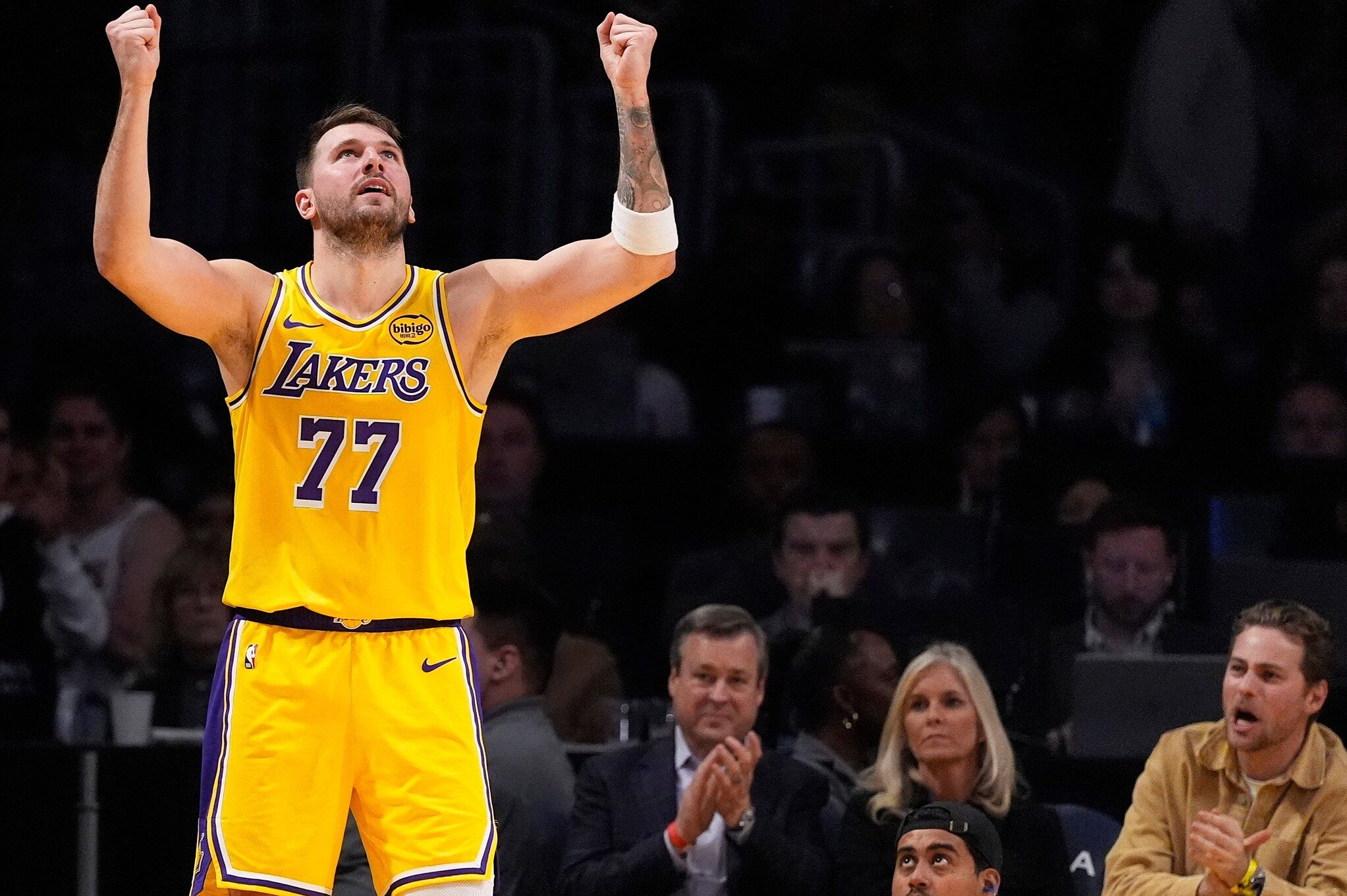 Los Angeles Lakers guard Luka Doncic celebrates after scoring and drawing a foul during an NBA basketball game against the Charlotte Hornets