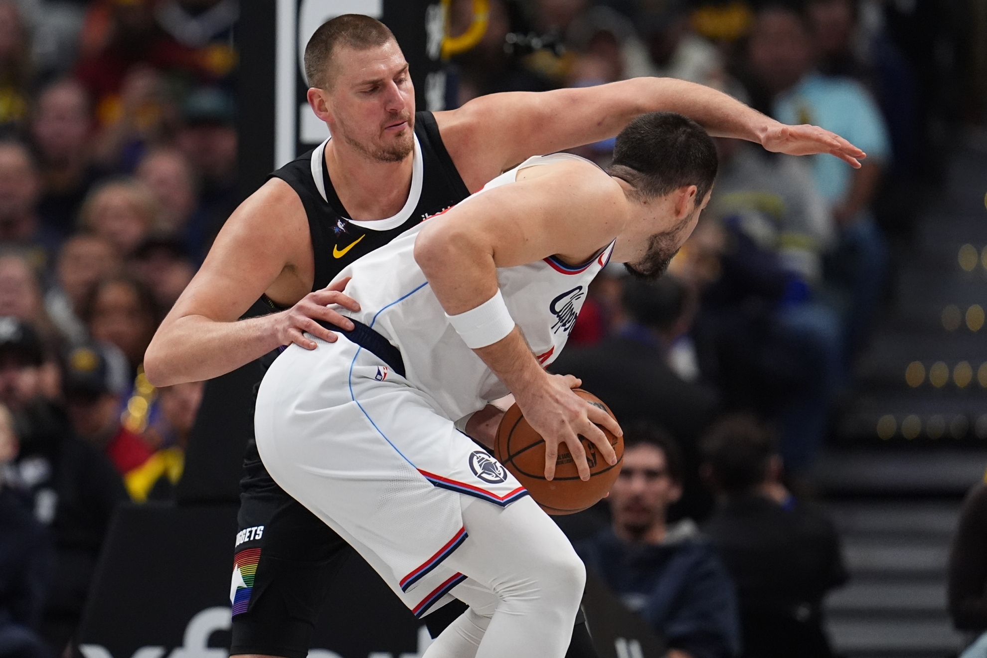 Clippers center Ivica Zubac, front, is covered by Denver Nuggets center Nikola Jokic.