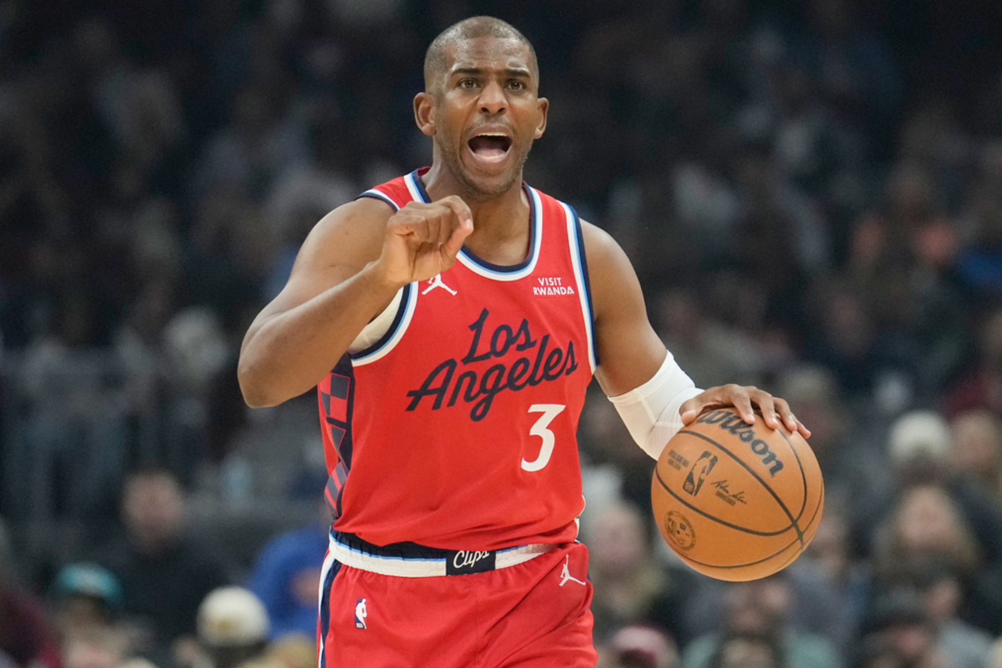 Los Angeles Clippers guard Chris Paul (3) shouts to his team as he brings the ball up the court in the first half of an NBA basketball game