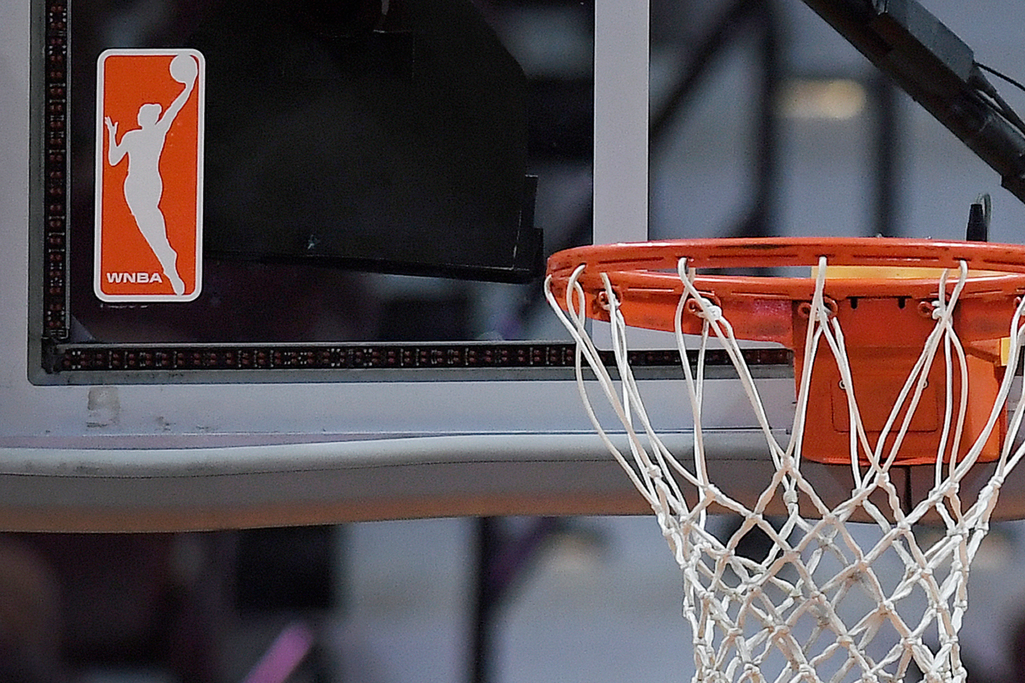 WNBA logo next to a hoop