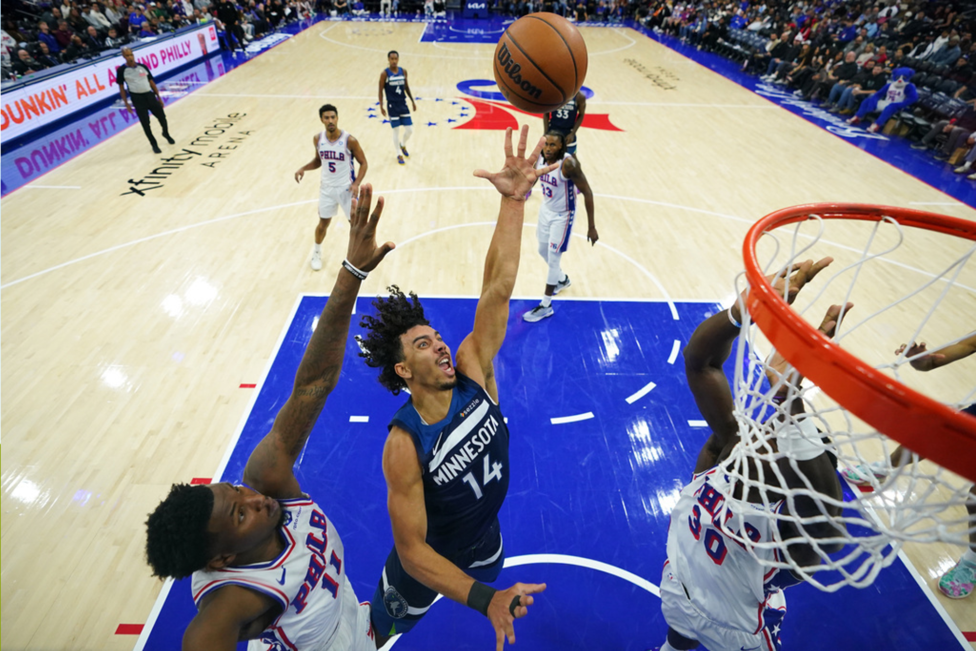 Minnesota Timberwolves' Jules Bernard (14) goes up for a shot against Philadelphia 76ers' Justin Edwards (11)