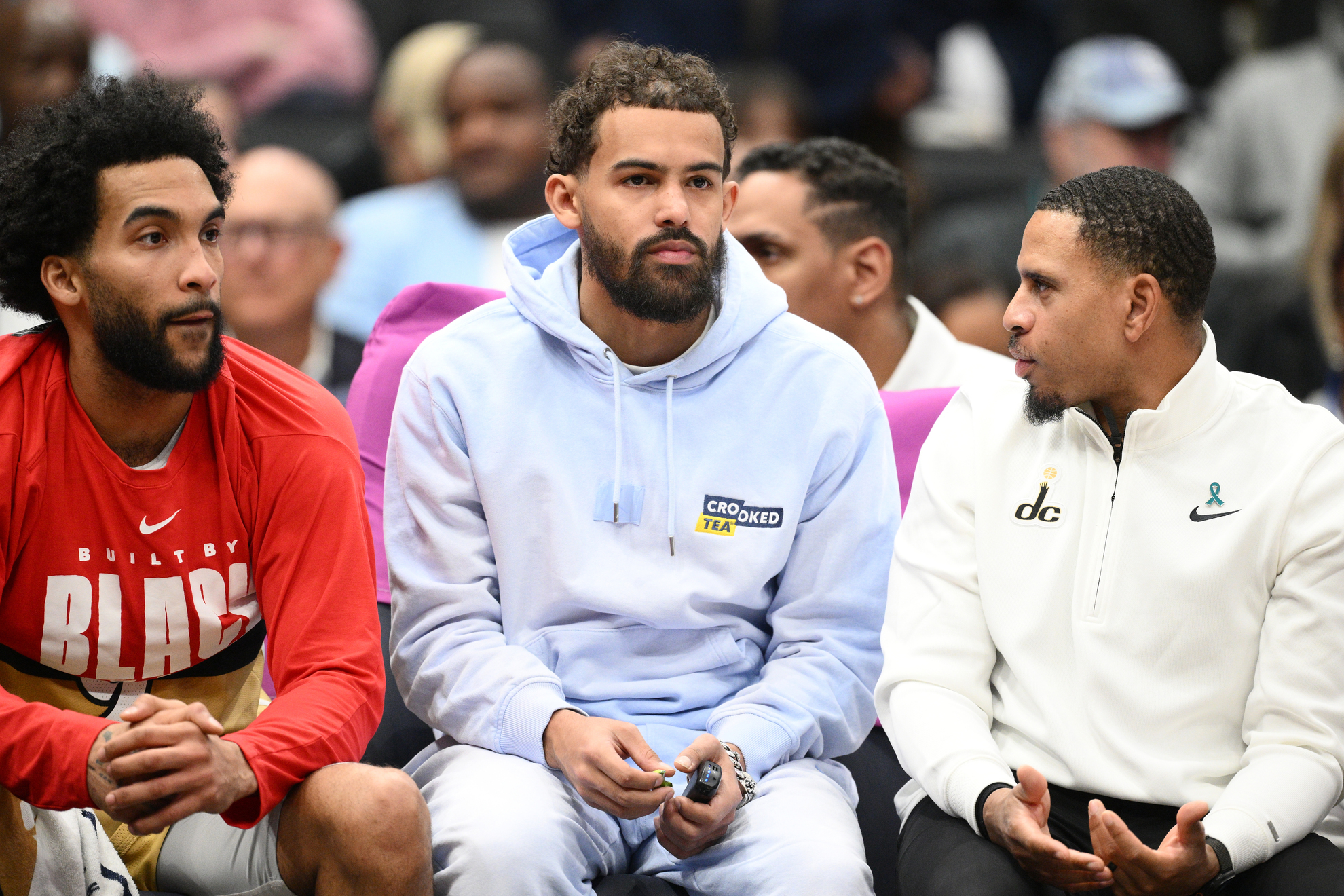 Washington Wizards guard Trae Young, center, looks on