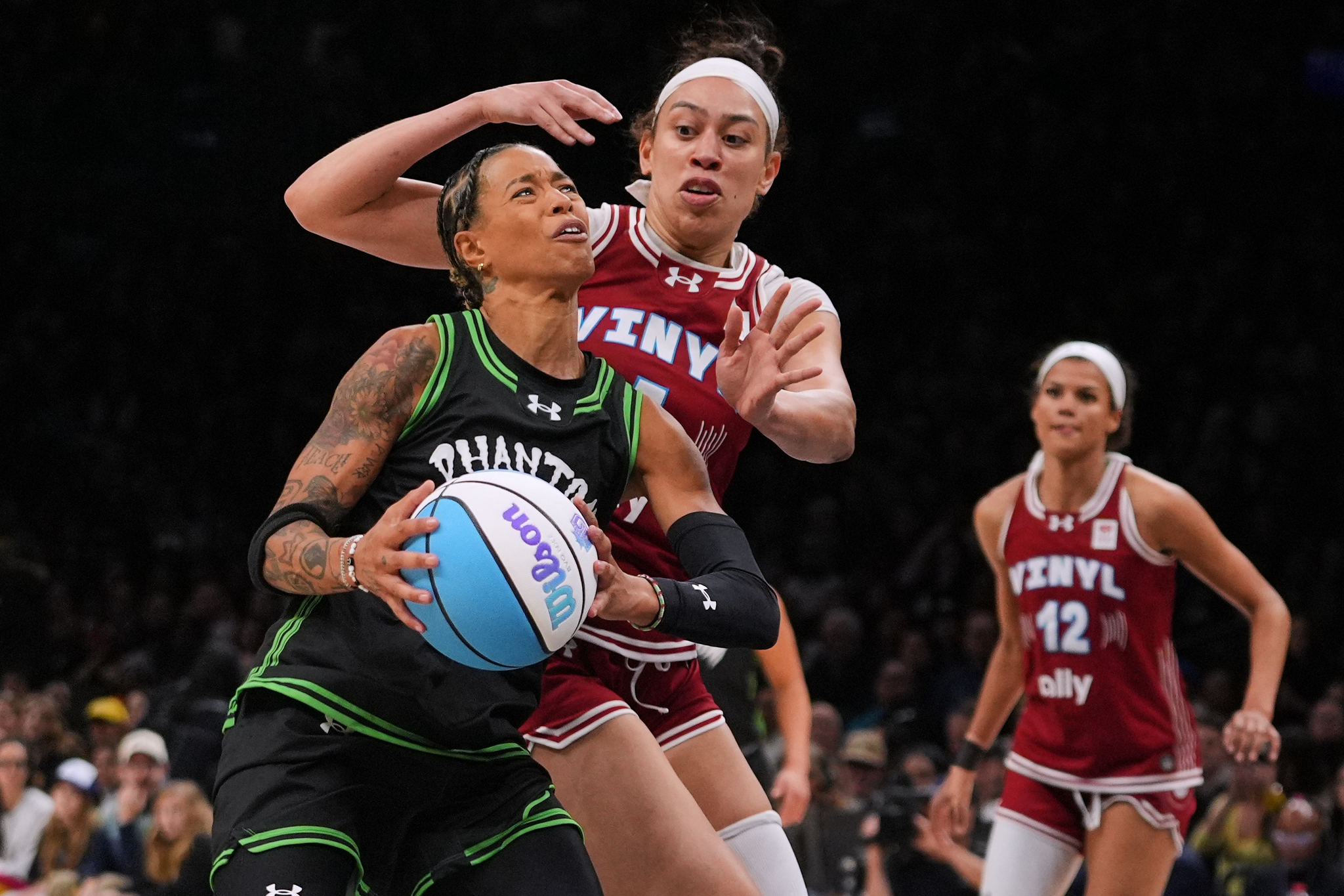 Phantom BC wing Natasha Cloud (15) drives past Vinyl BC forward Dearica Hamby (5) during the second half of a semifinal in their Unrivaled 3-on-3 basketball game,