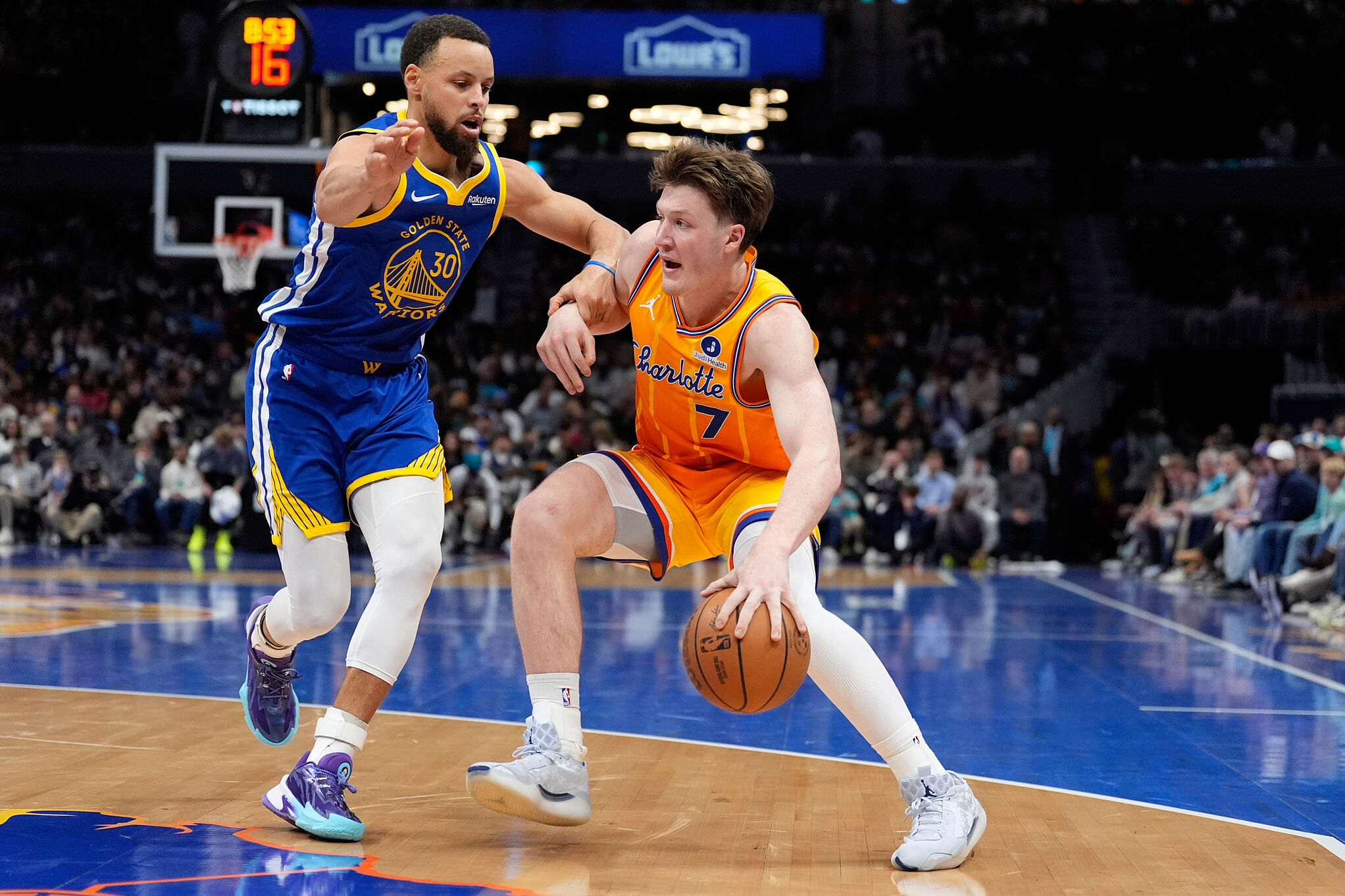 Golden State Warriors guard Stephen Curry guards Charlotte Hornets guard Kon Knueppel during an NBA basketball game