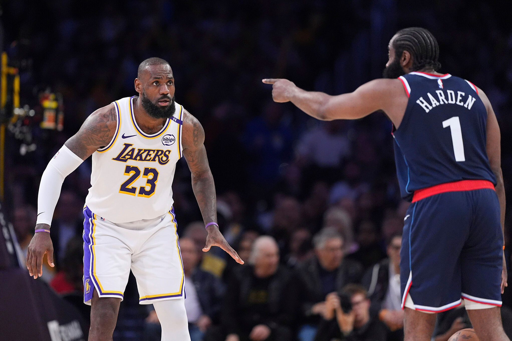 Los Angeles Lakers forward LeBron James, left, watches Los Angeles Clippers guard James Harden as he gestures an NBA basketball game