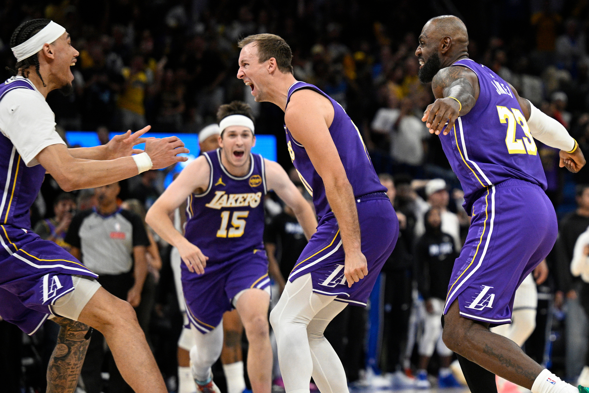 Los Angeles Lakers guard Luke Kennard, second from right, celebrates his winning basket vs Orlando Magic