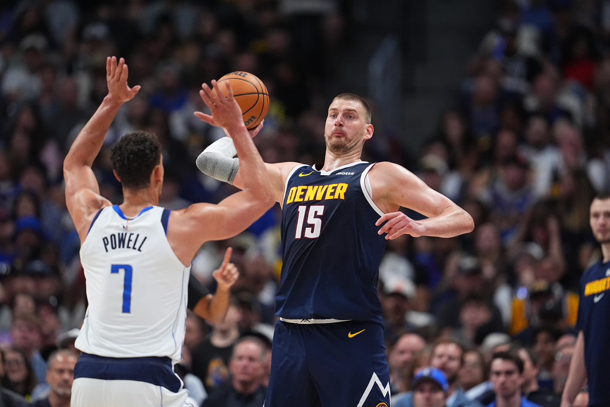 Denver Nuggets center Nikola Jokic takes aim at the basket downcourt over Dallas Mavericks forward Dwight Powell