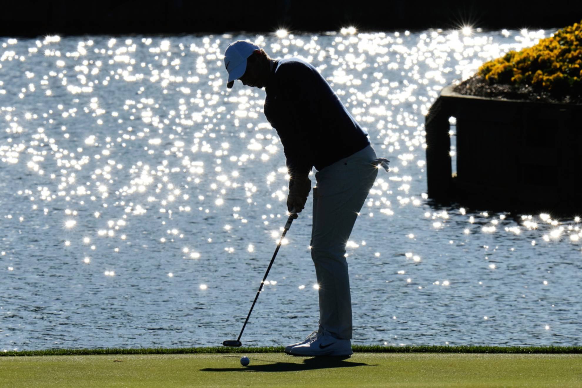 Rory McIlroy, of Northern Ireland, putts on the 17th green during a playoff round of The Players Championship /