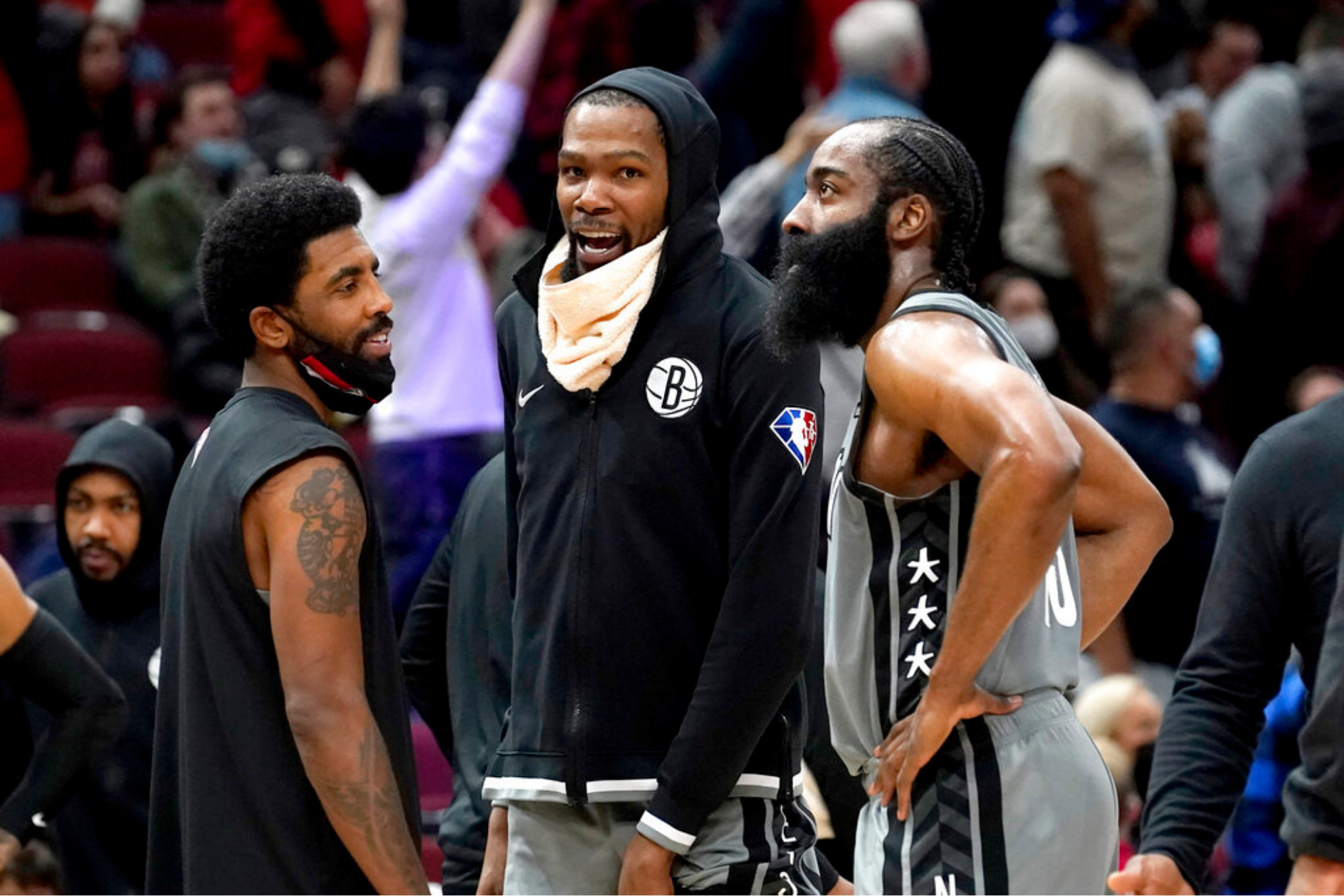 Brooklyn Nets' Kevin Durant, center, smiles with teammates Kyrie Irving, left, and James Harden