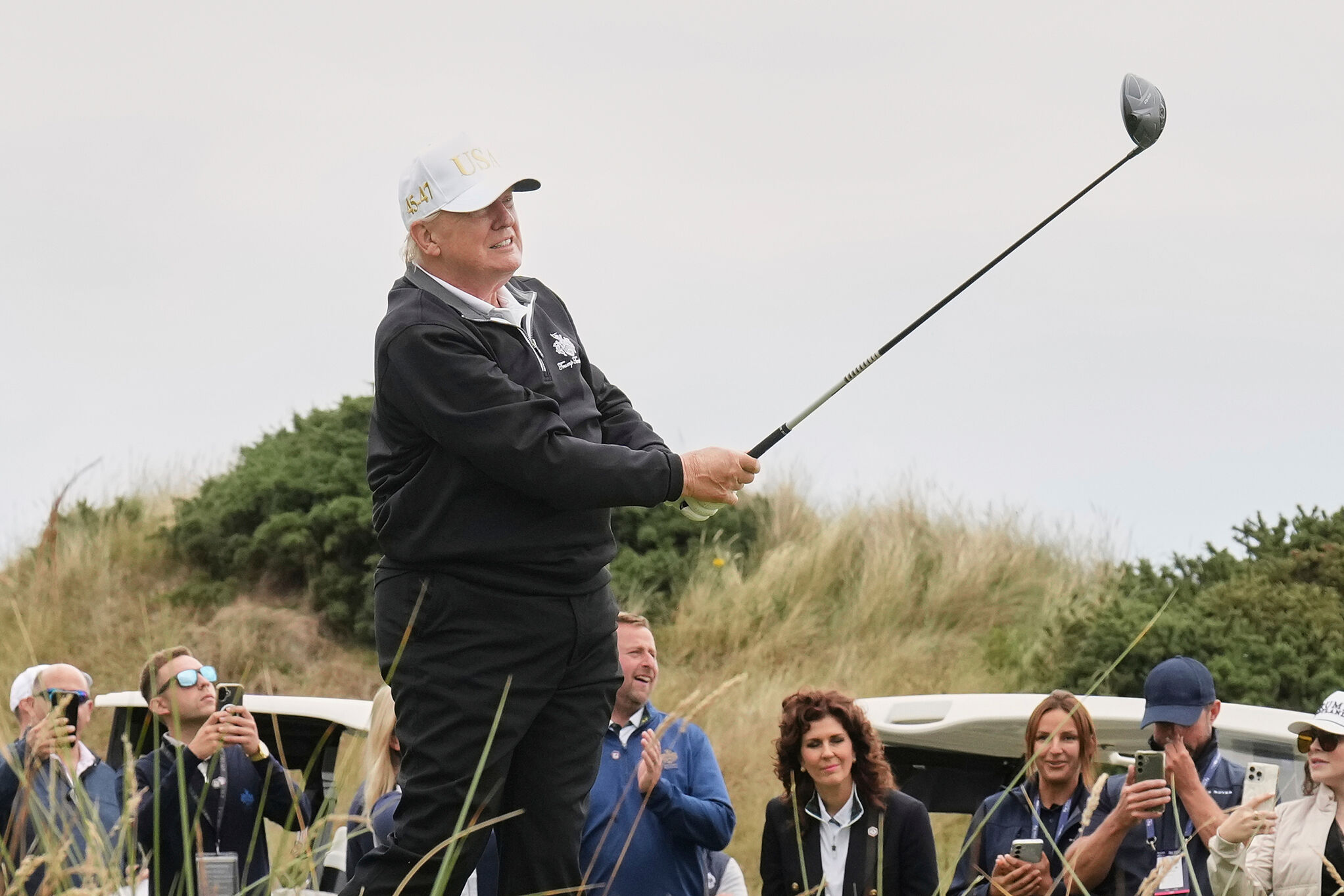 Donald Trump tees off during the opening ceremony for the Trump International Golf Links golf course, near Aberdeen, Scotland, July 29, 2025
