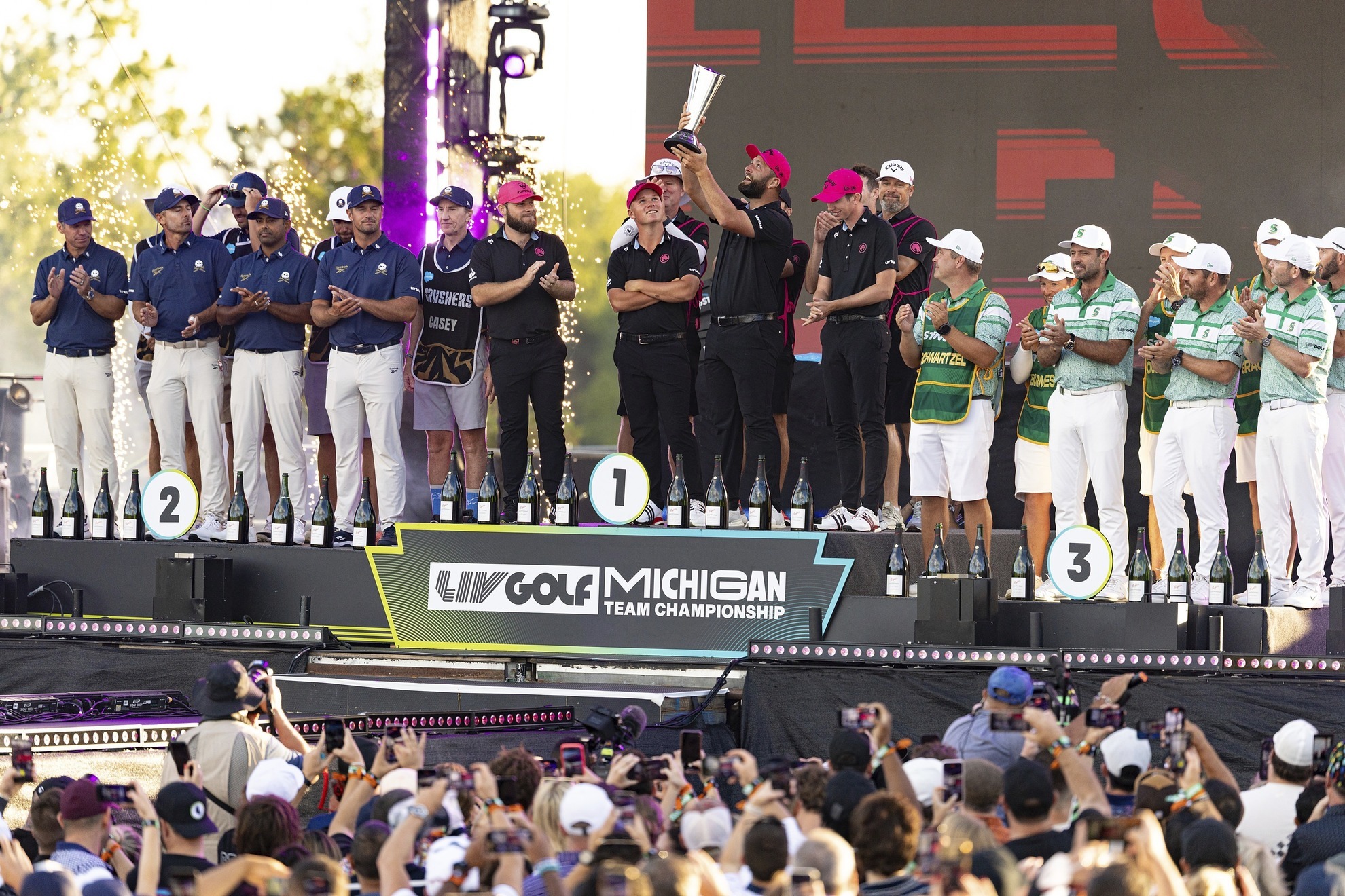 Team Champion Captain Jon Rahm of Legion XIII lifts the trophy surrounded by his teammates Tyrrell Hatton, Caleb Surratt and Tom McKibbin