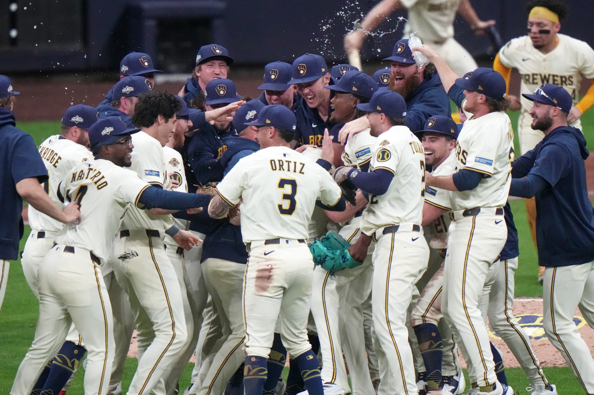 The Milwaukee Brewers celebrate after winning Game 5 of baseball's National League Division Series against the Chicago Cubs