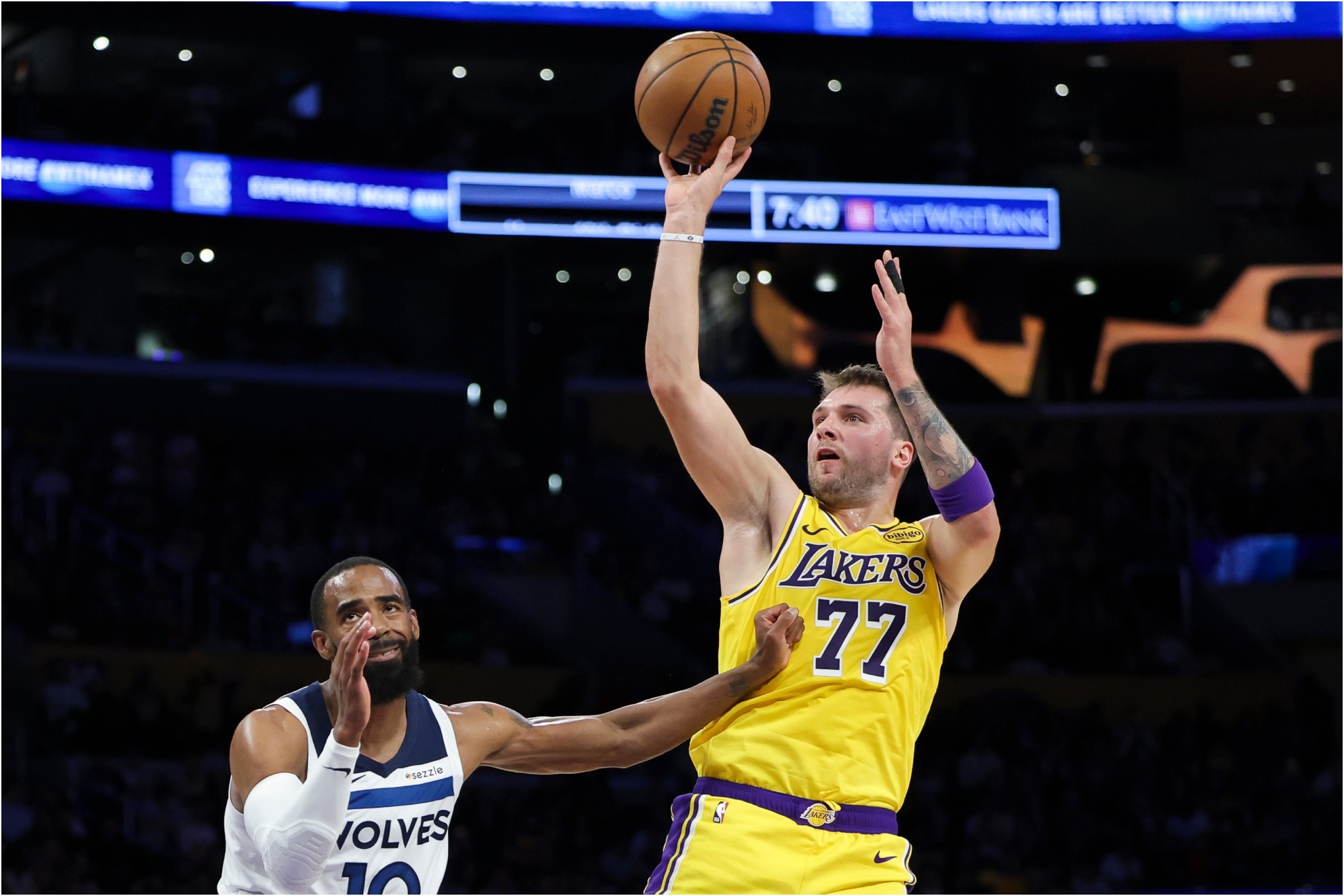 Los Angeles Lakers guard Luka Doncic shoots against the Minnesota Timberwolves guard Mike Conley.