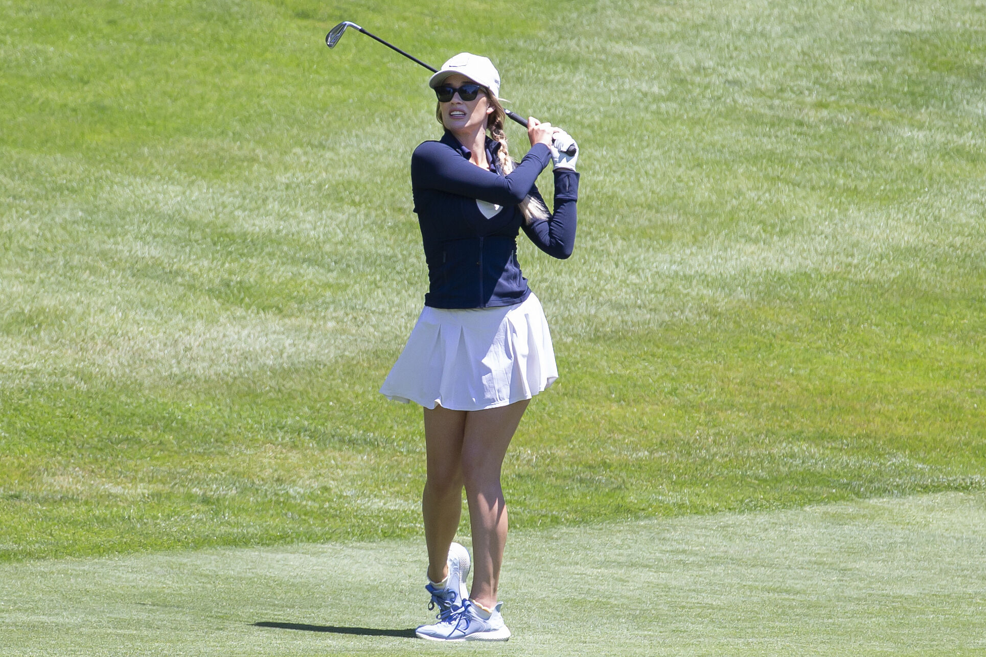 Paige Spiranac playing golf.