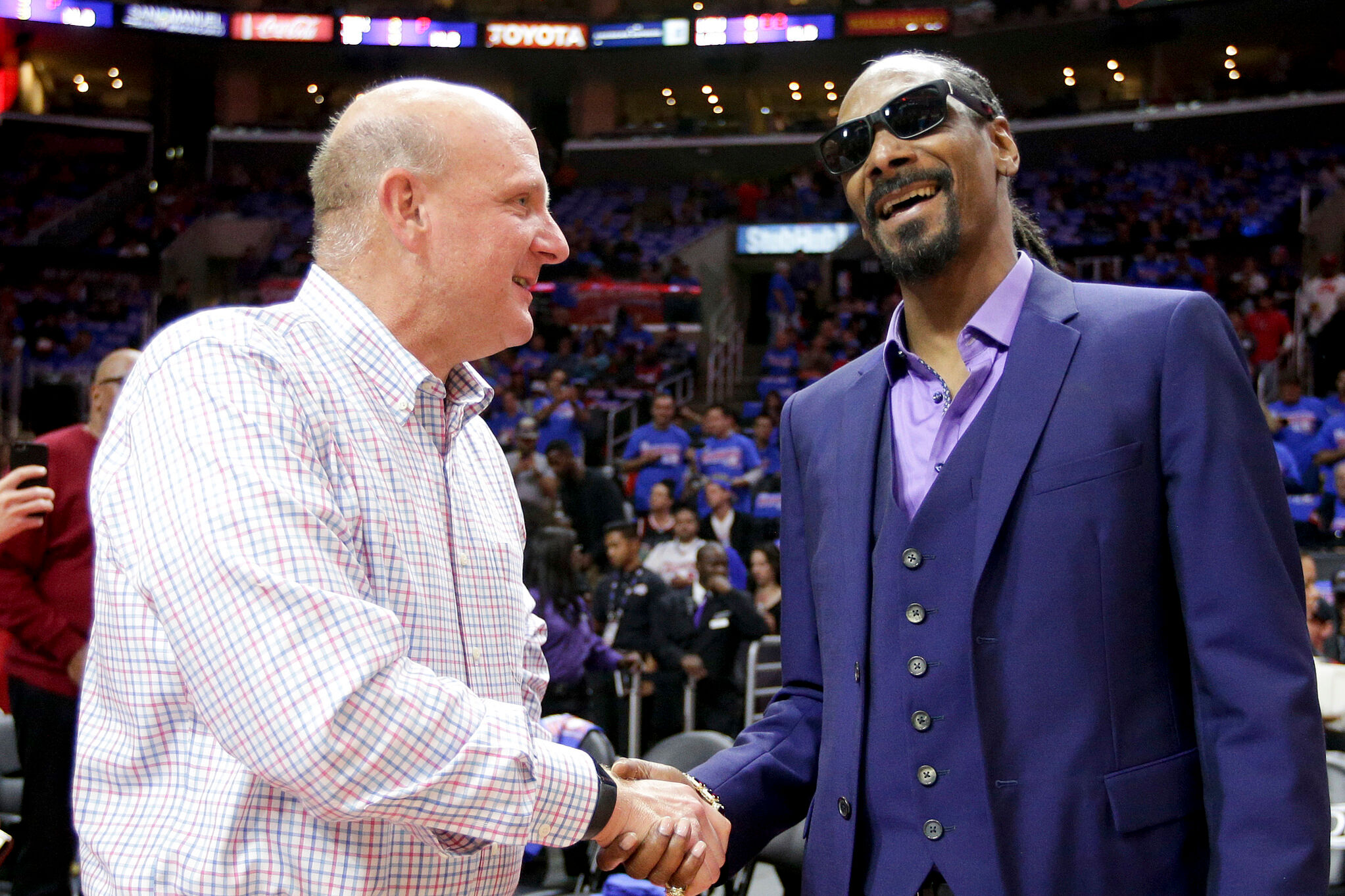 Los Angeles Clippers owner Steve Ballmer, left, chats with entertainer Snoop Dogg in a NBA basketball playoff series between the Los Angeles Clippers and the Houston Rocket