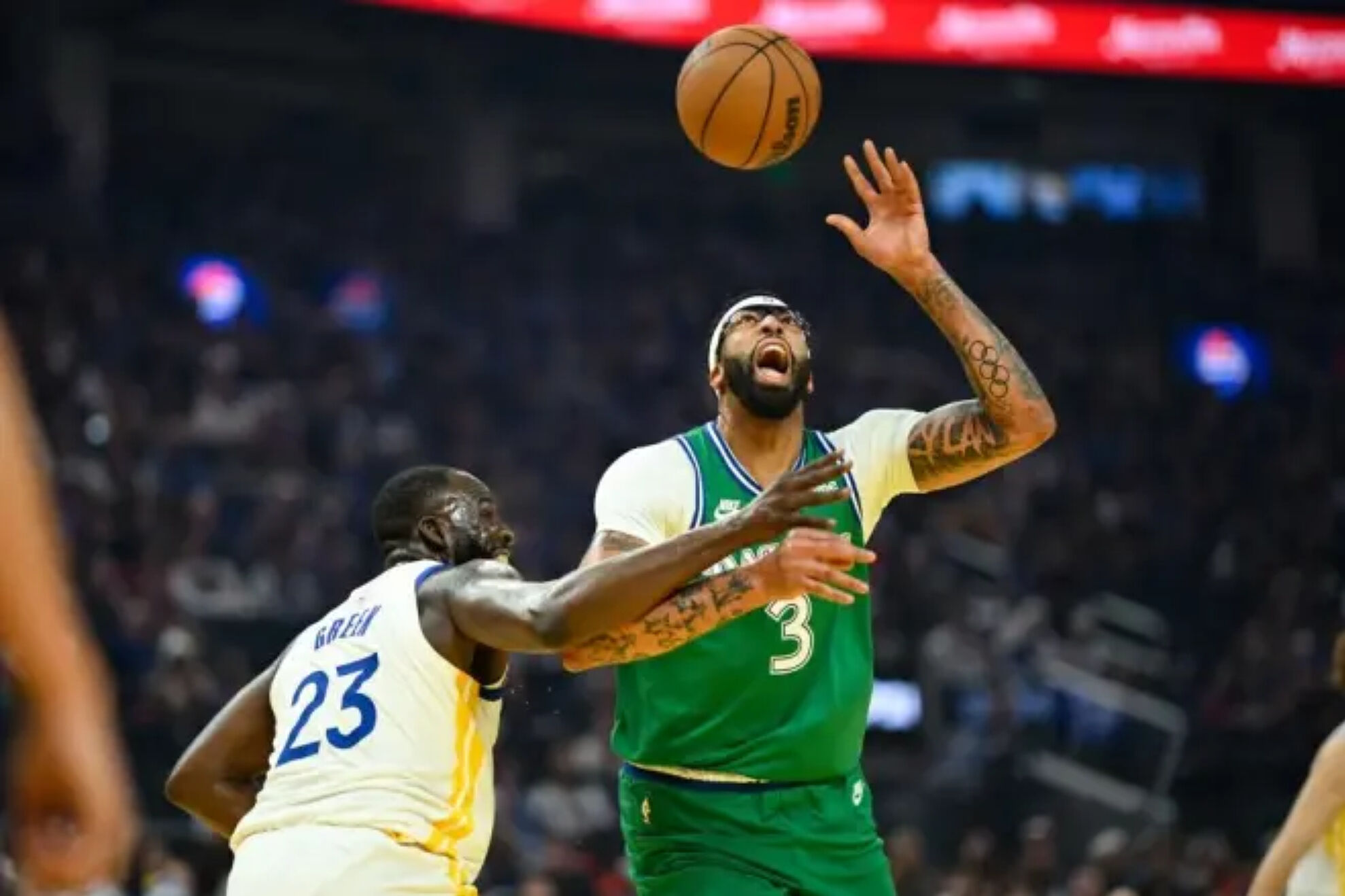 Draymond Green (23), forward for the Golden State Warriors, fouled Anthony Davis (3) of the Dallas Mavericks during the first half of the NBA game played on Thursday, December 25, 2025 in San Francisco.