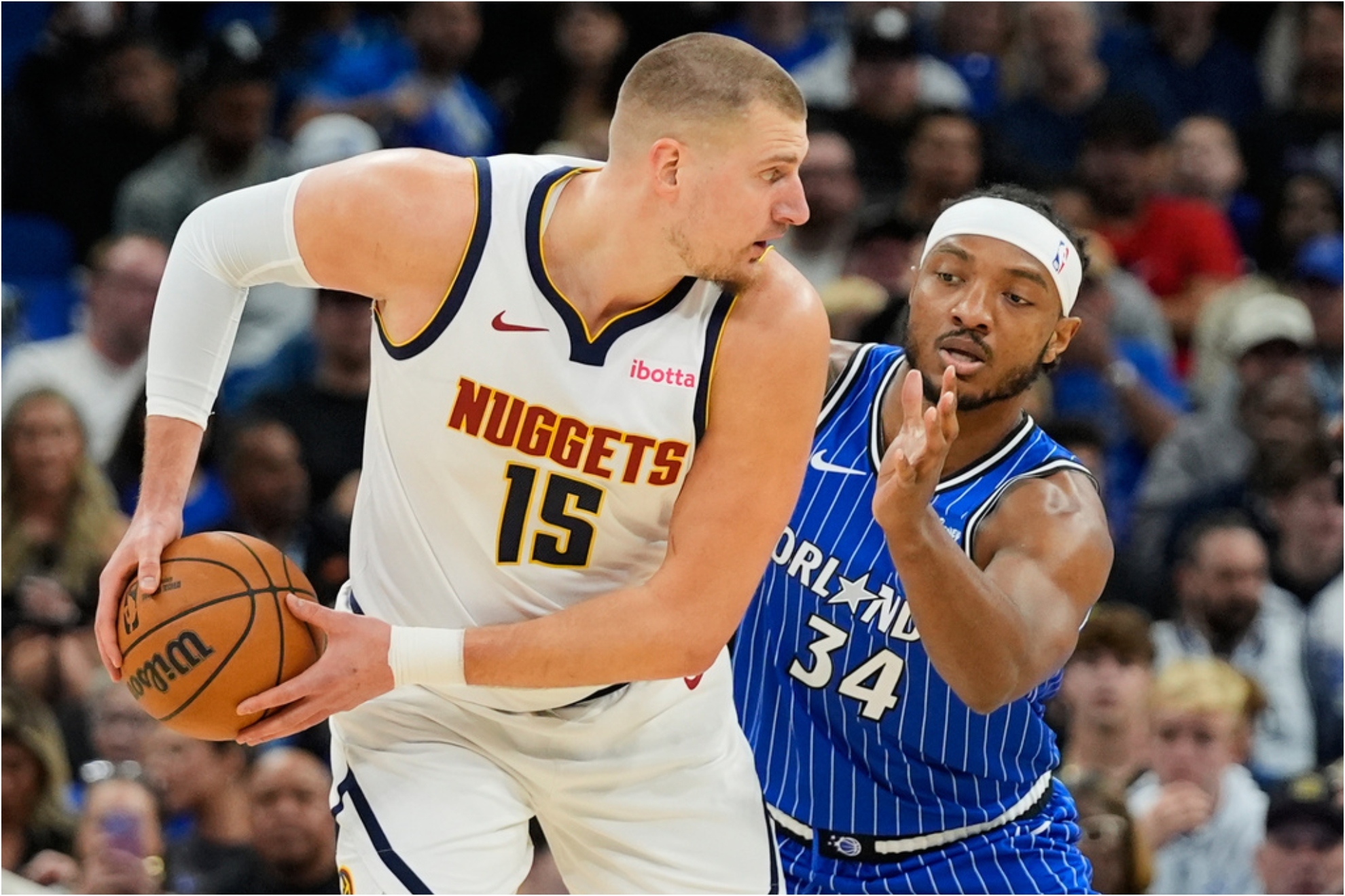 Nikola Jokic (15) looks for a way around Orlando Magic center Wendell Carter Jr.