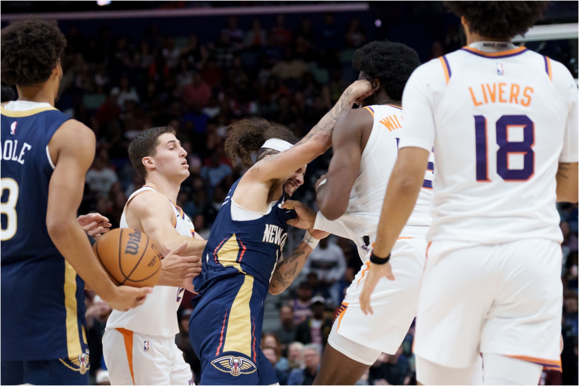 New Orleans Pelicans guard Jose Alvarado, left, and Phoenix Suns center Mark Williams (15) get into a scrum.