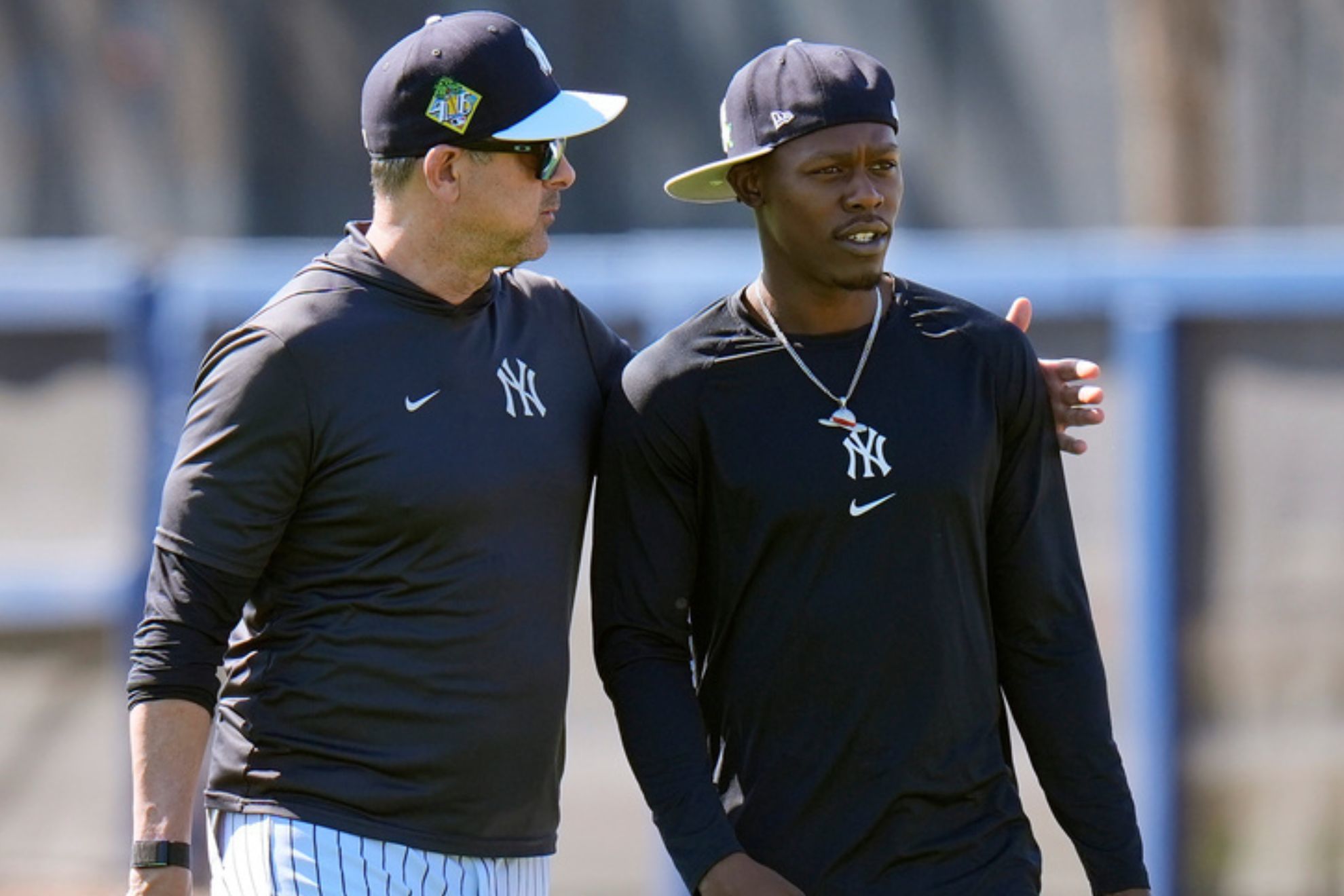 Aaron Boone, right, hugs second baseman Jazz Chisholm Jr.