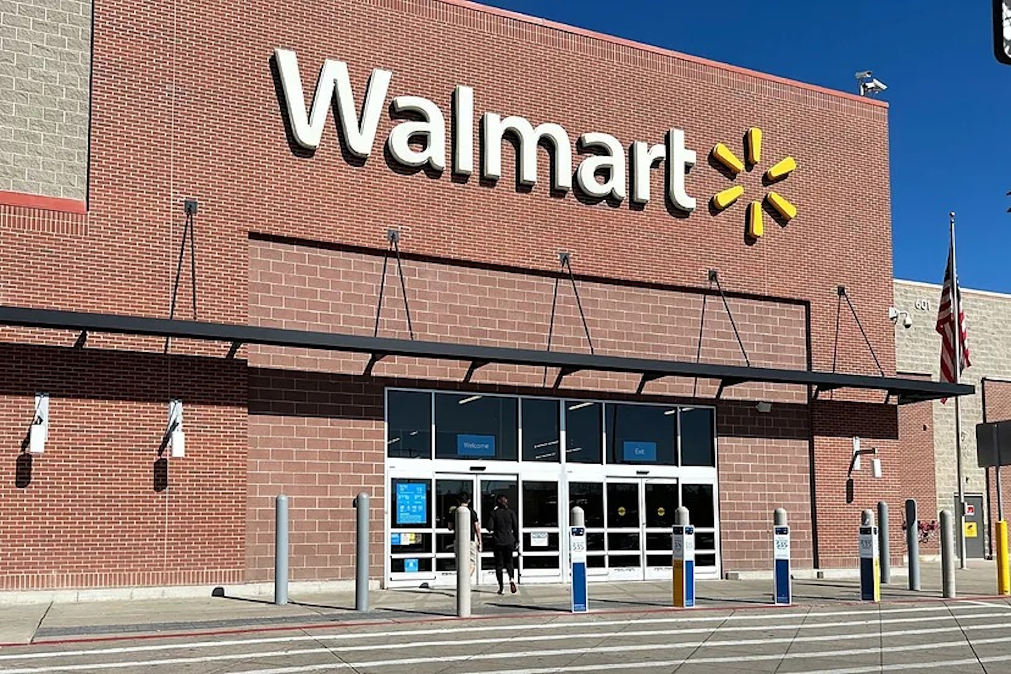A shopper heads into a Walmart store.