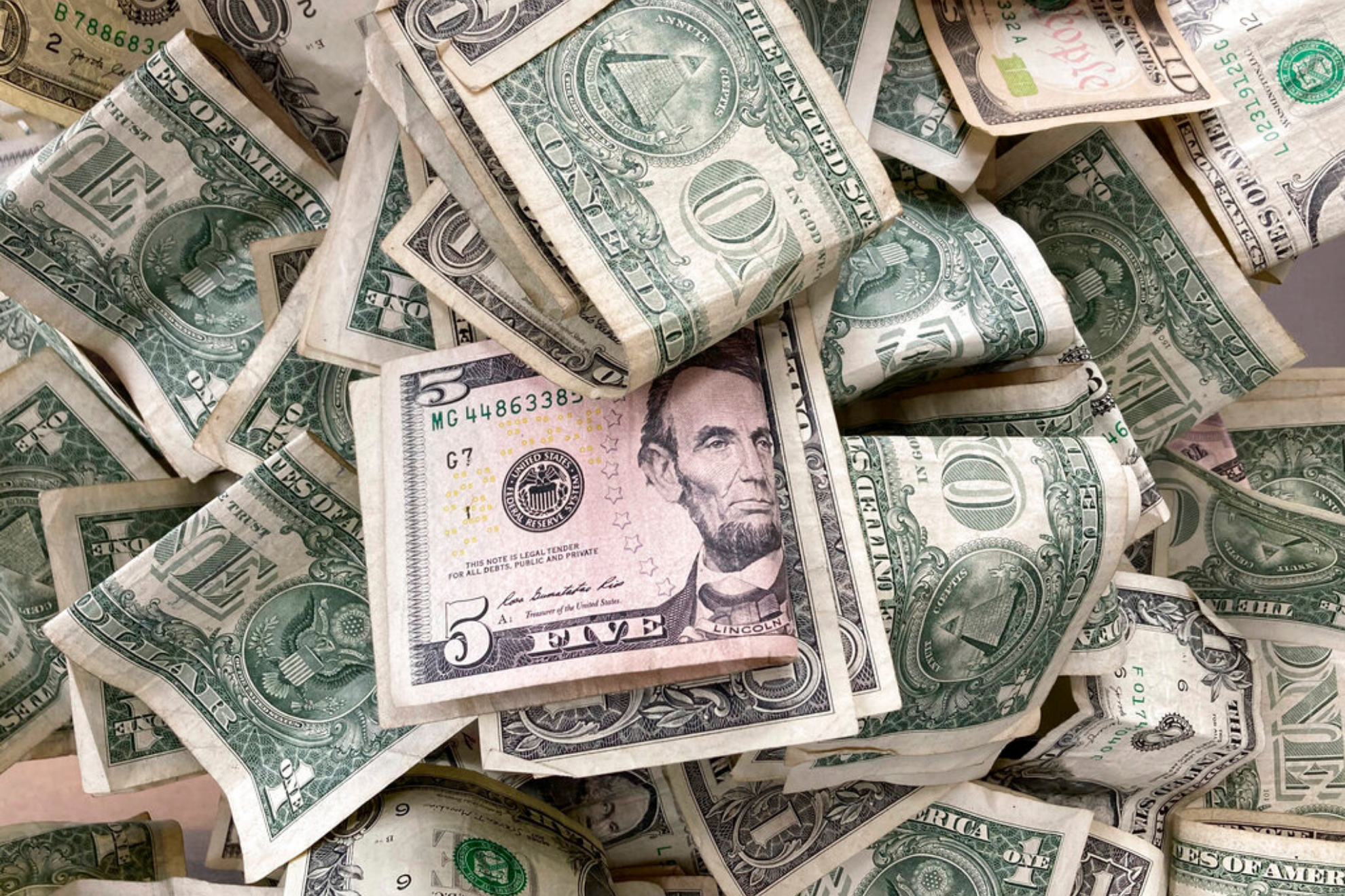 Dollar bills are deposited in a tip box
